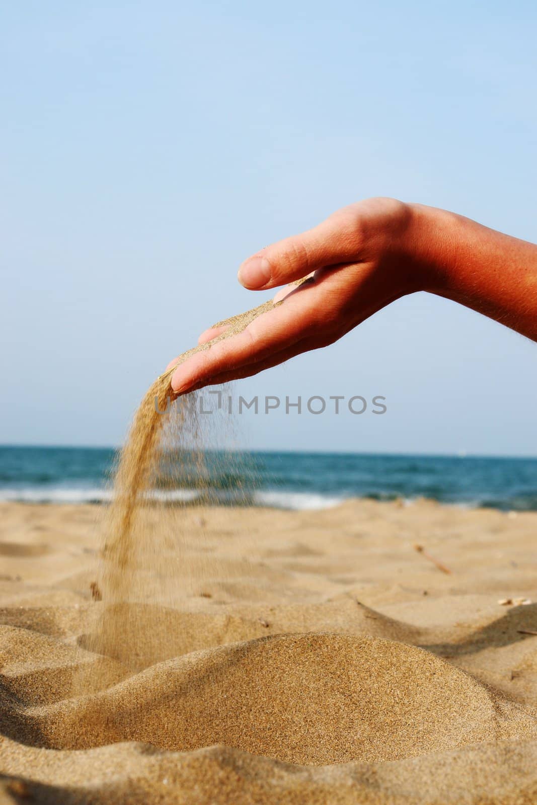 sand running through hands as a symbol for time running, lost etc.............