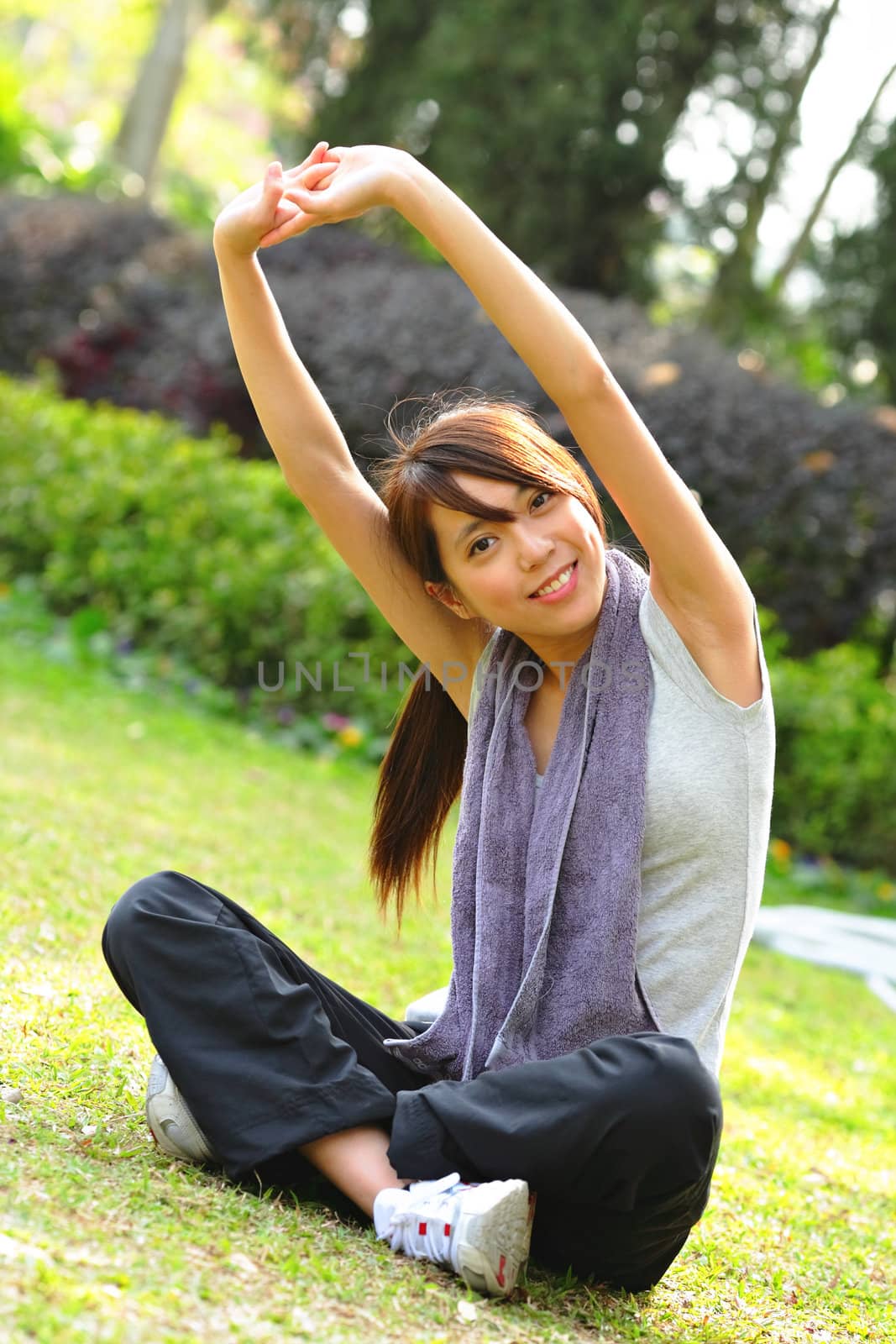 woman doing stretching exercise in park