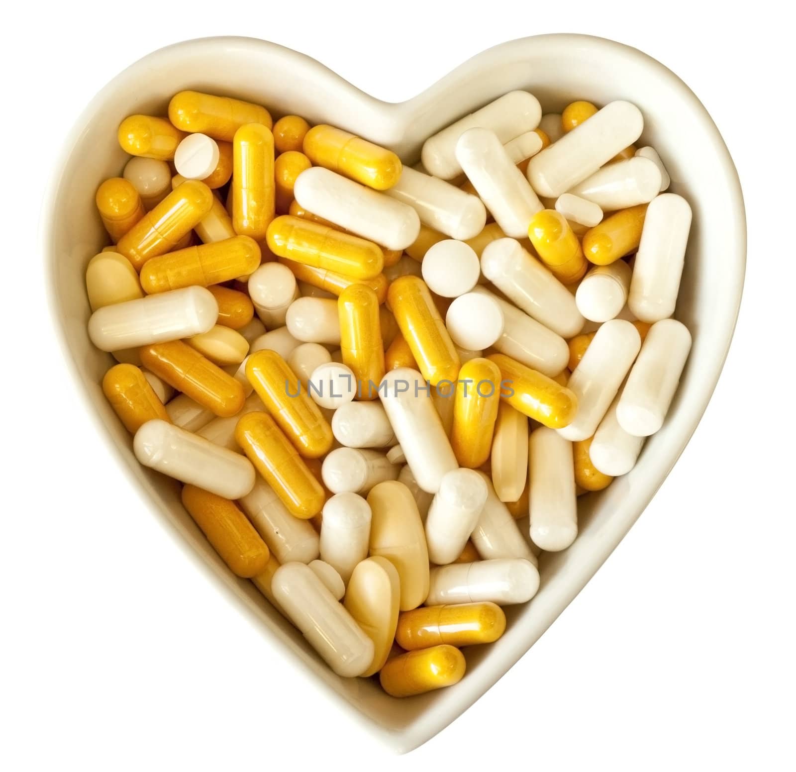 Heart shaped bowl filled with medicine or diet supplements, with clipping path