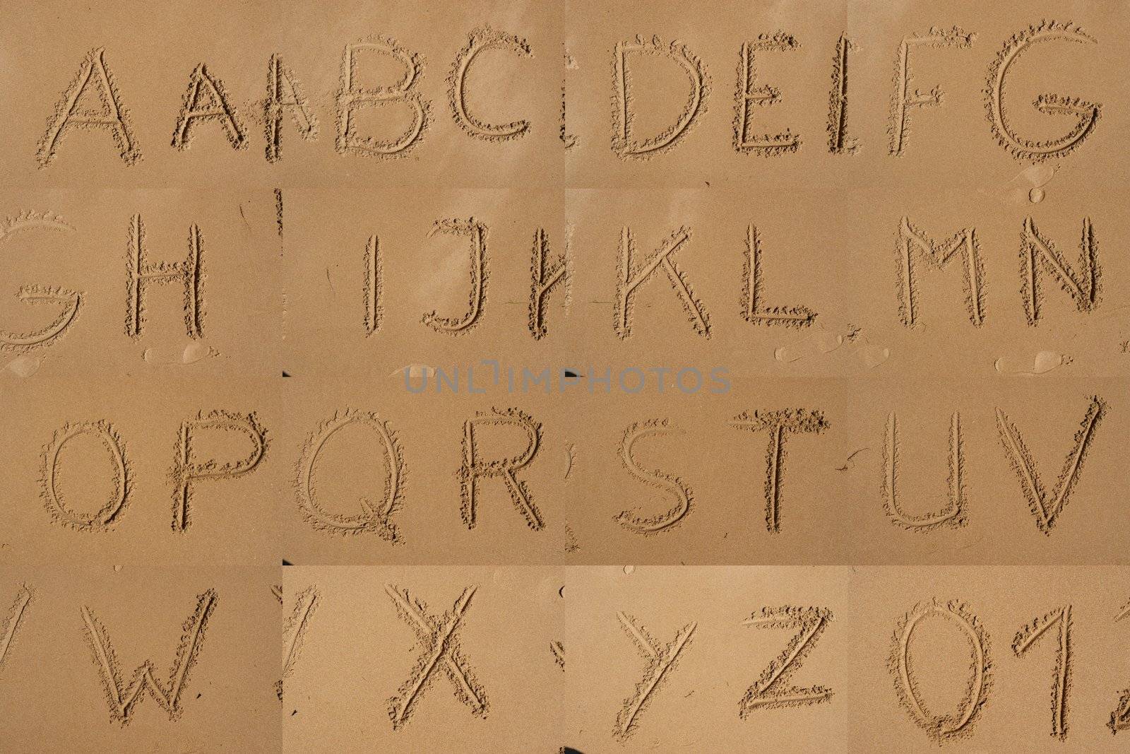 The Alphabet Written In Sand On A Beach. by yucas