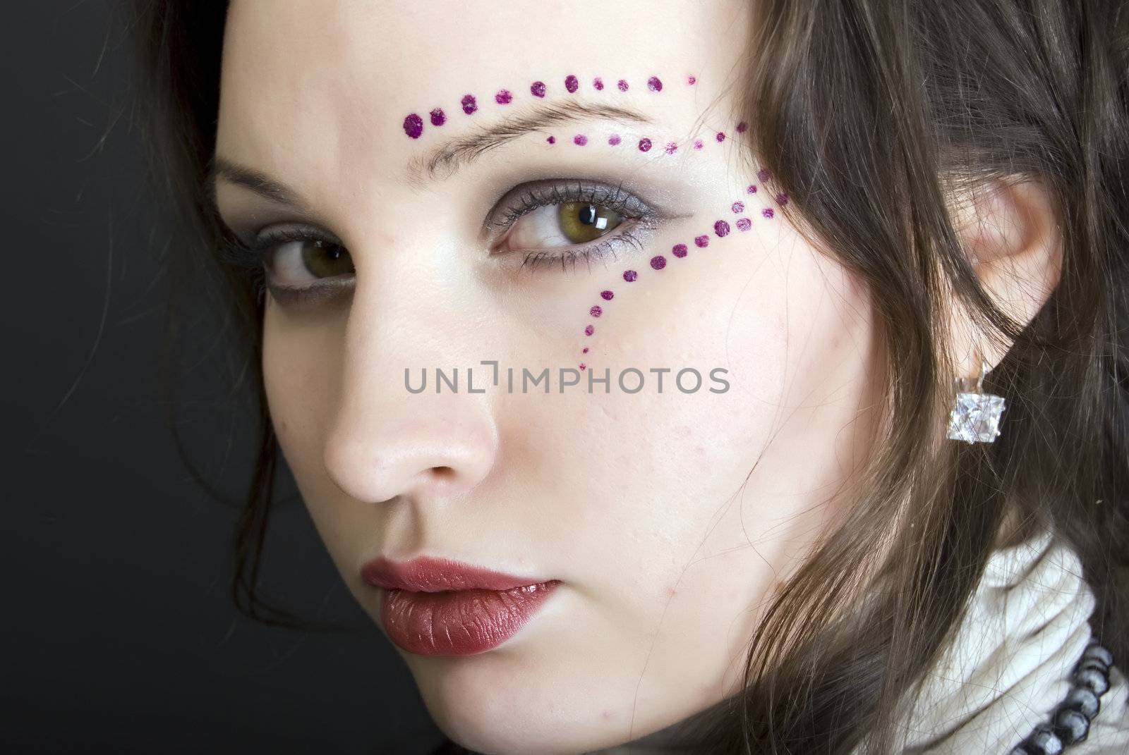 Portrait of a young beautiful brunette with eastern make-up