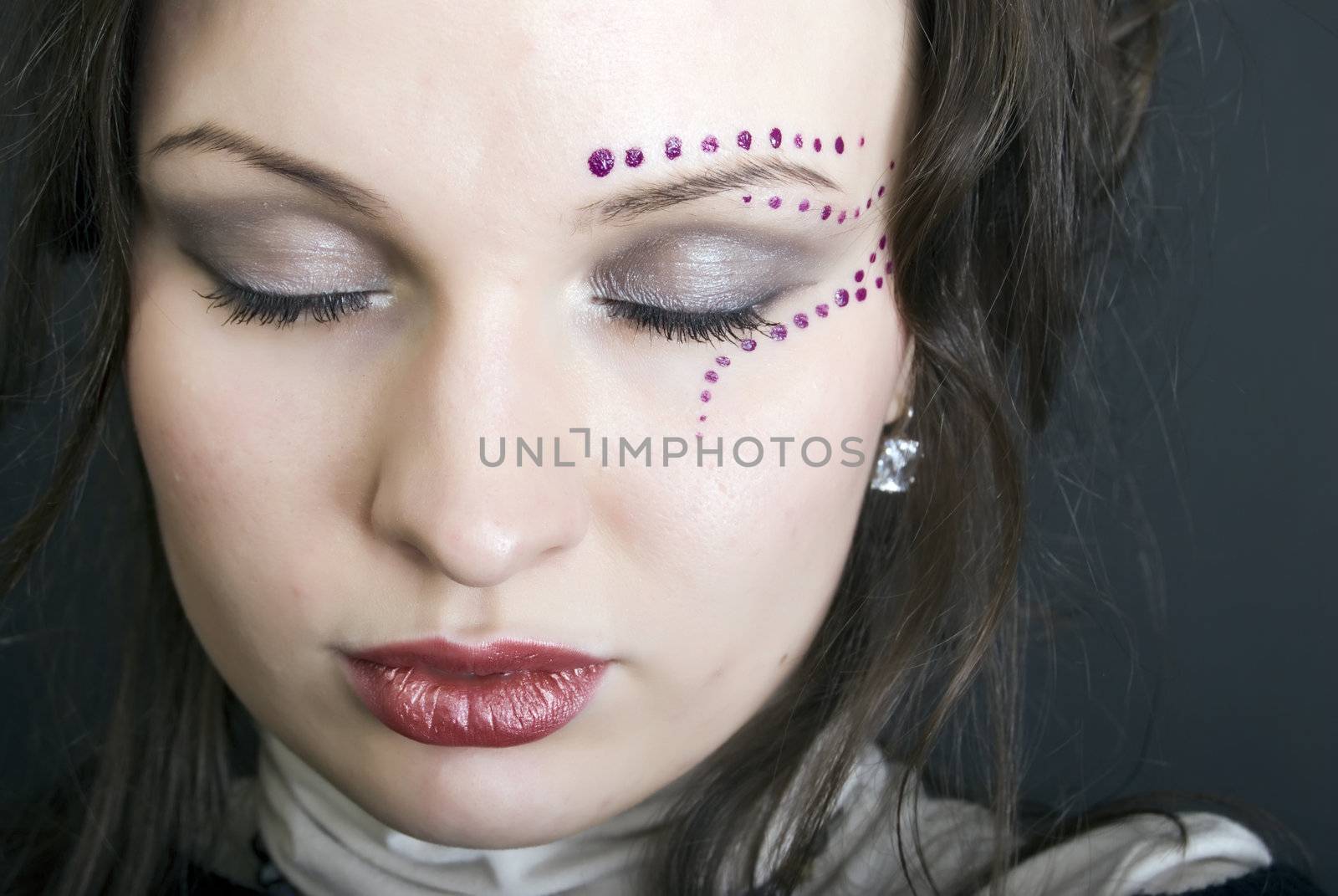 Portrait of a young beautiful brunette with make-up