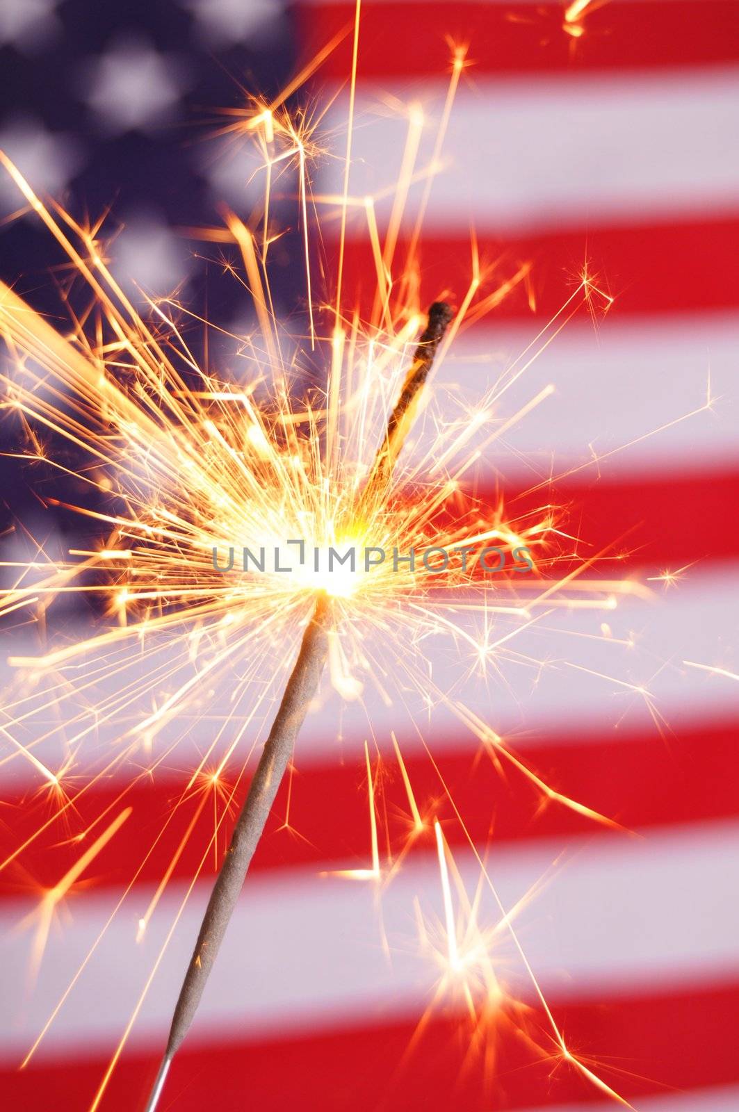 sparkler and usa flag showing 4th of july