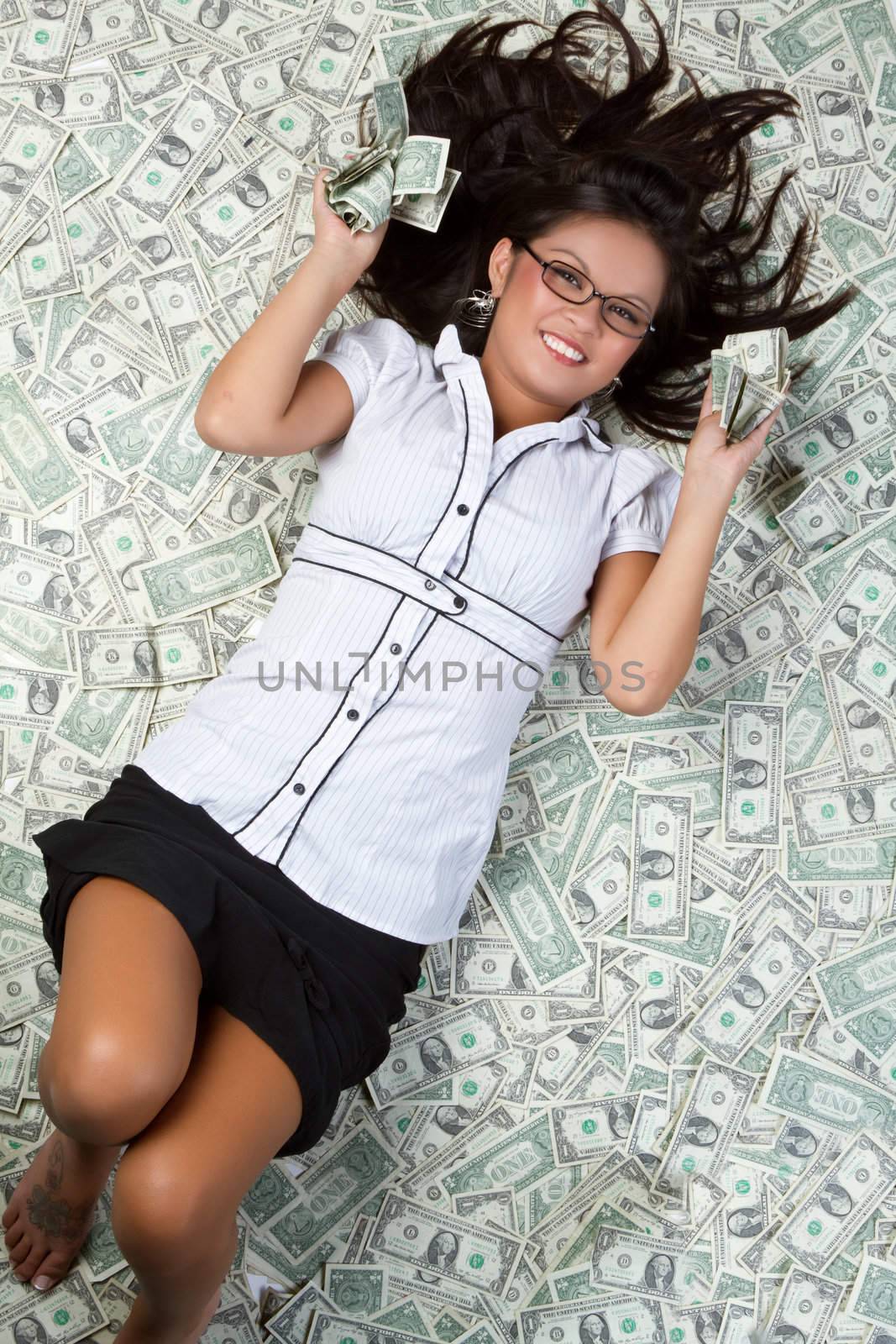 Smiling woman laying in money