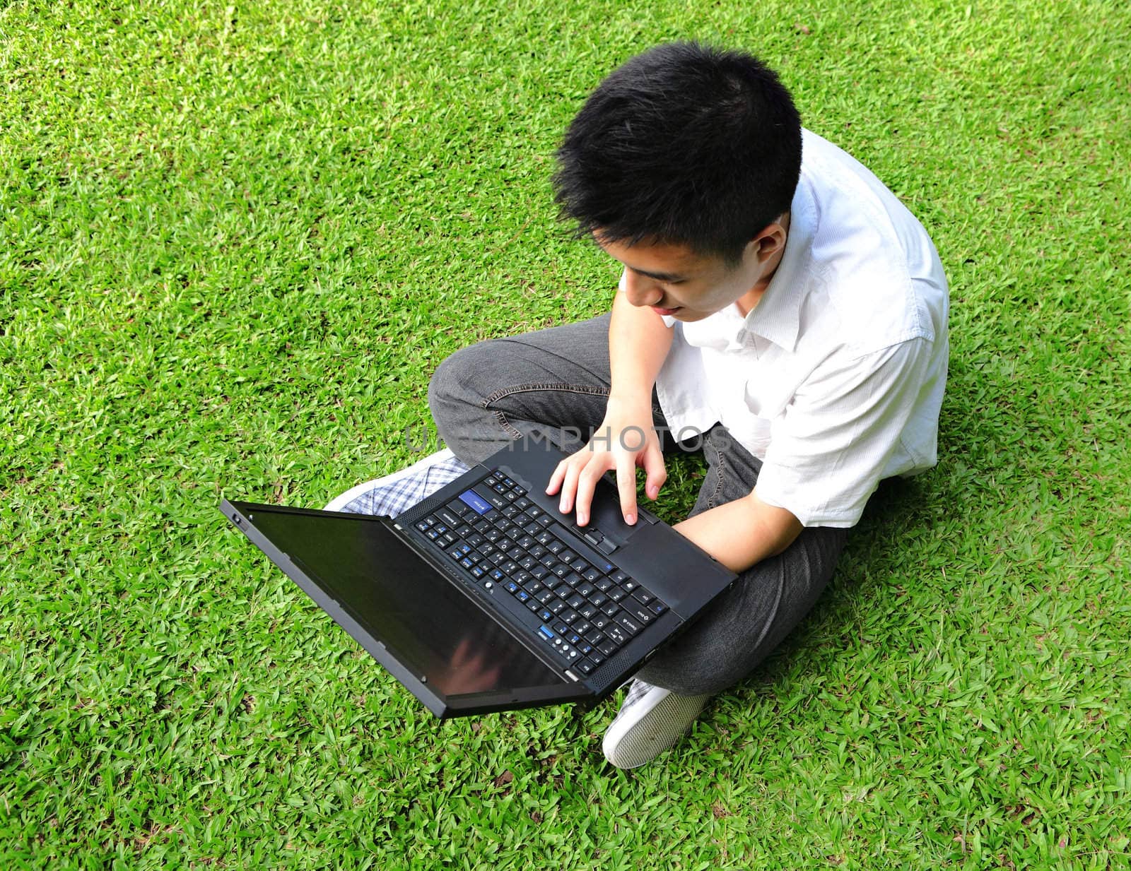 asian man using computer outdoor