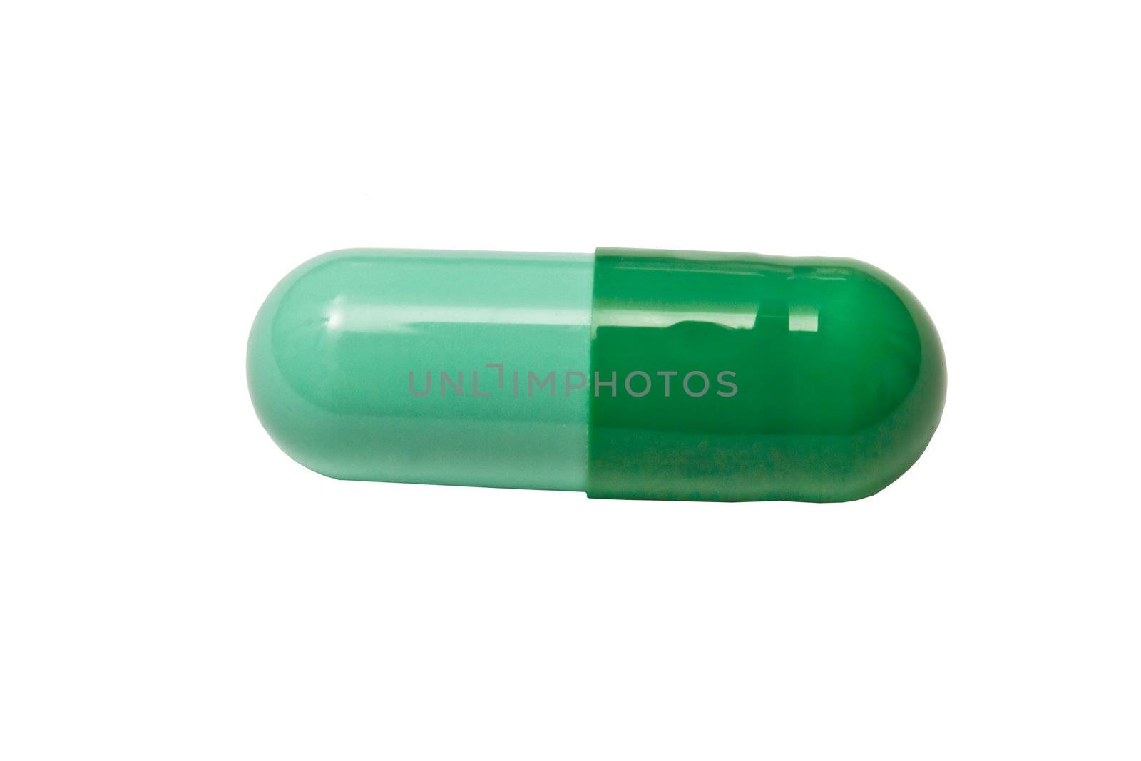Green capsule isolated on white background 
