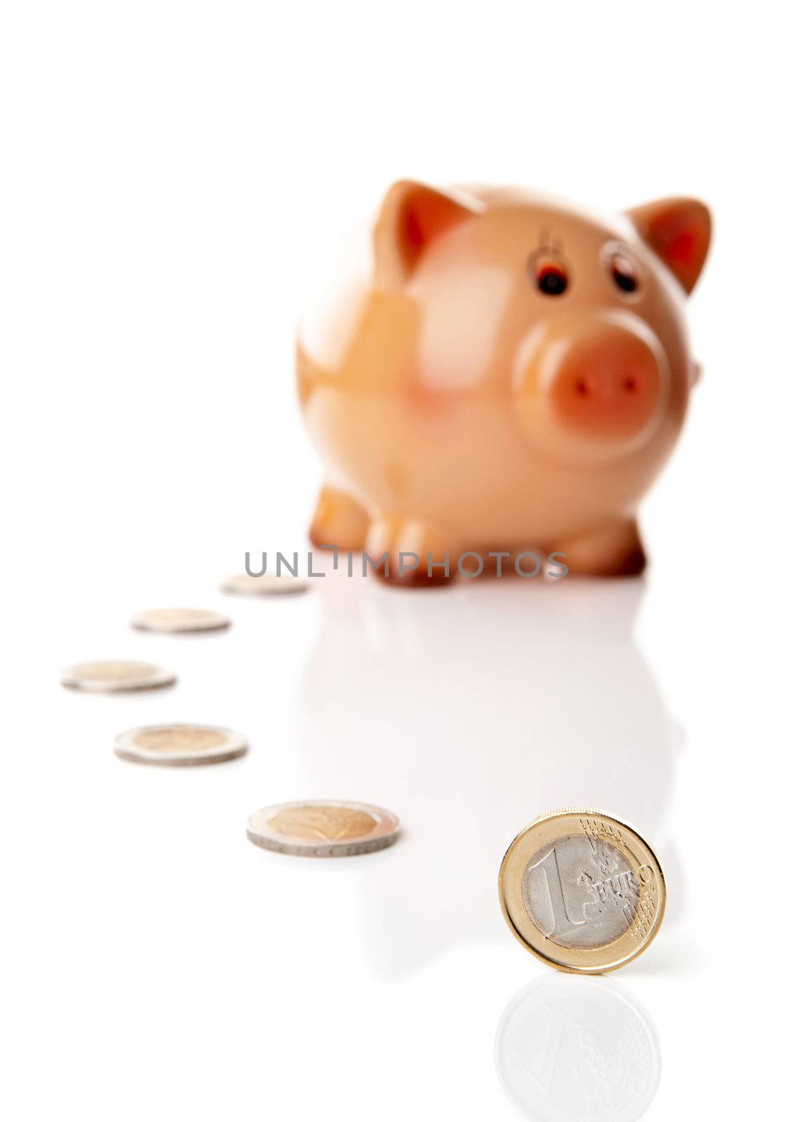 One Euro coin in fornt of a Piggy bank isolated over a white background