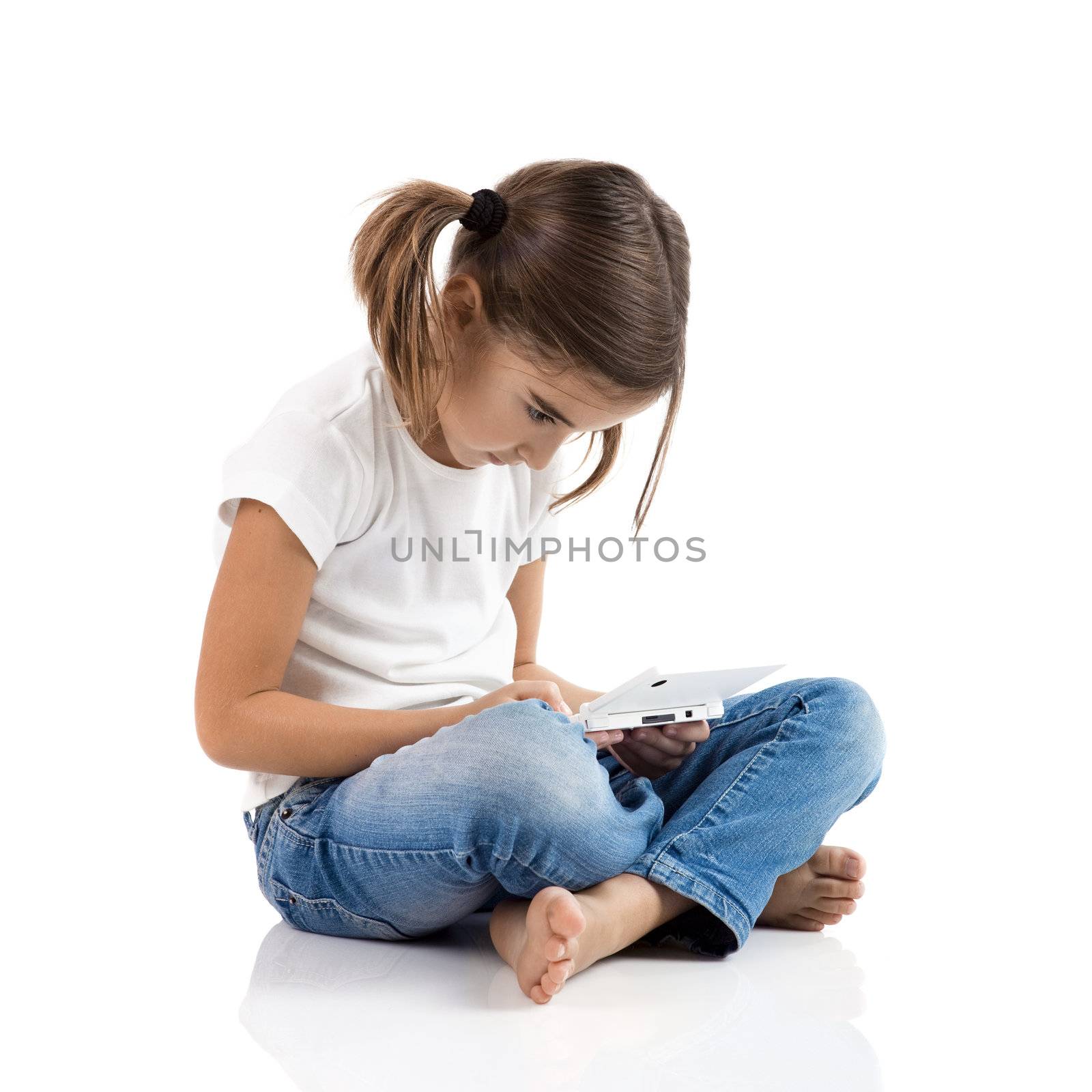 Little girl sitting on floor playing a video-game