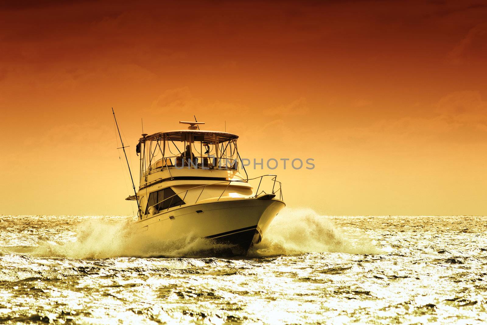 boat on a caribbean sea with sunset