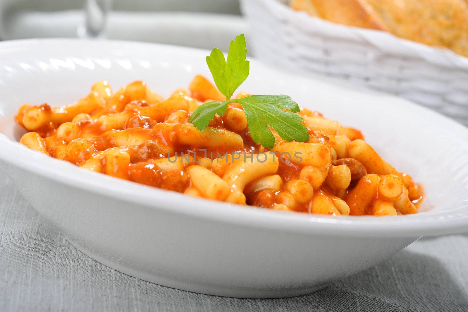Bowl of macaroni with a spicy tomato beef sauce.