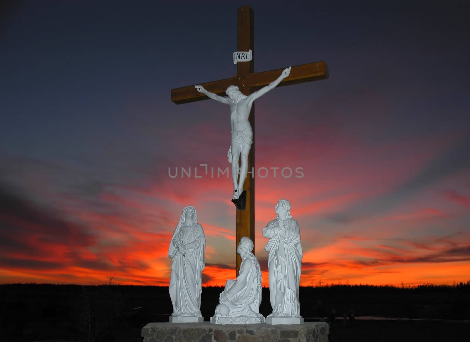 Crucifixion scene in front of colorfull sunset