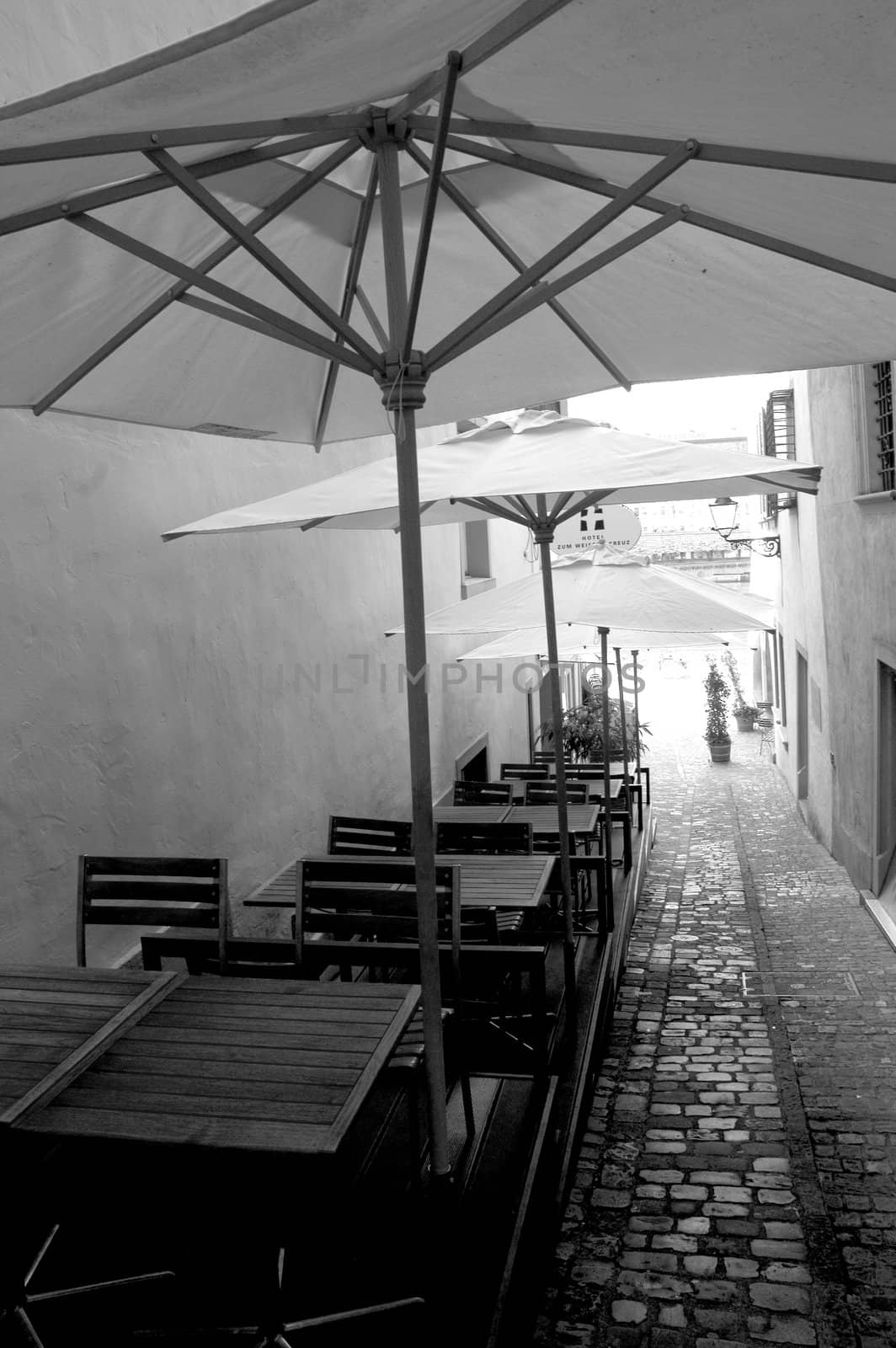 Classic Swiss alley with tables and chairs.