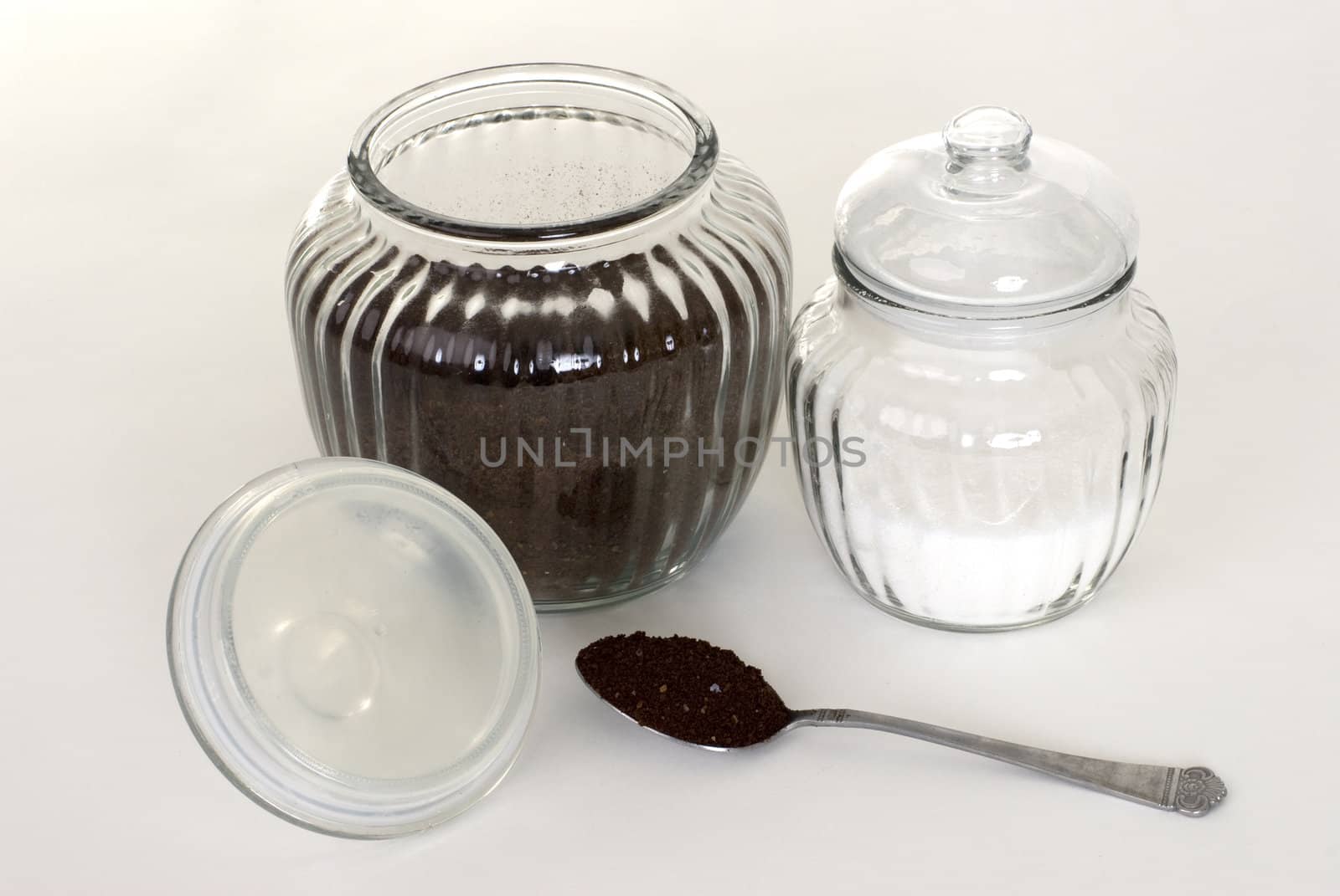 A jar of coffee and sugar on a white background.
