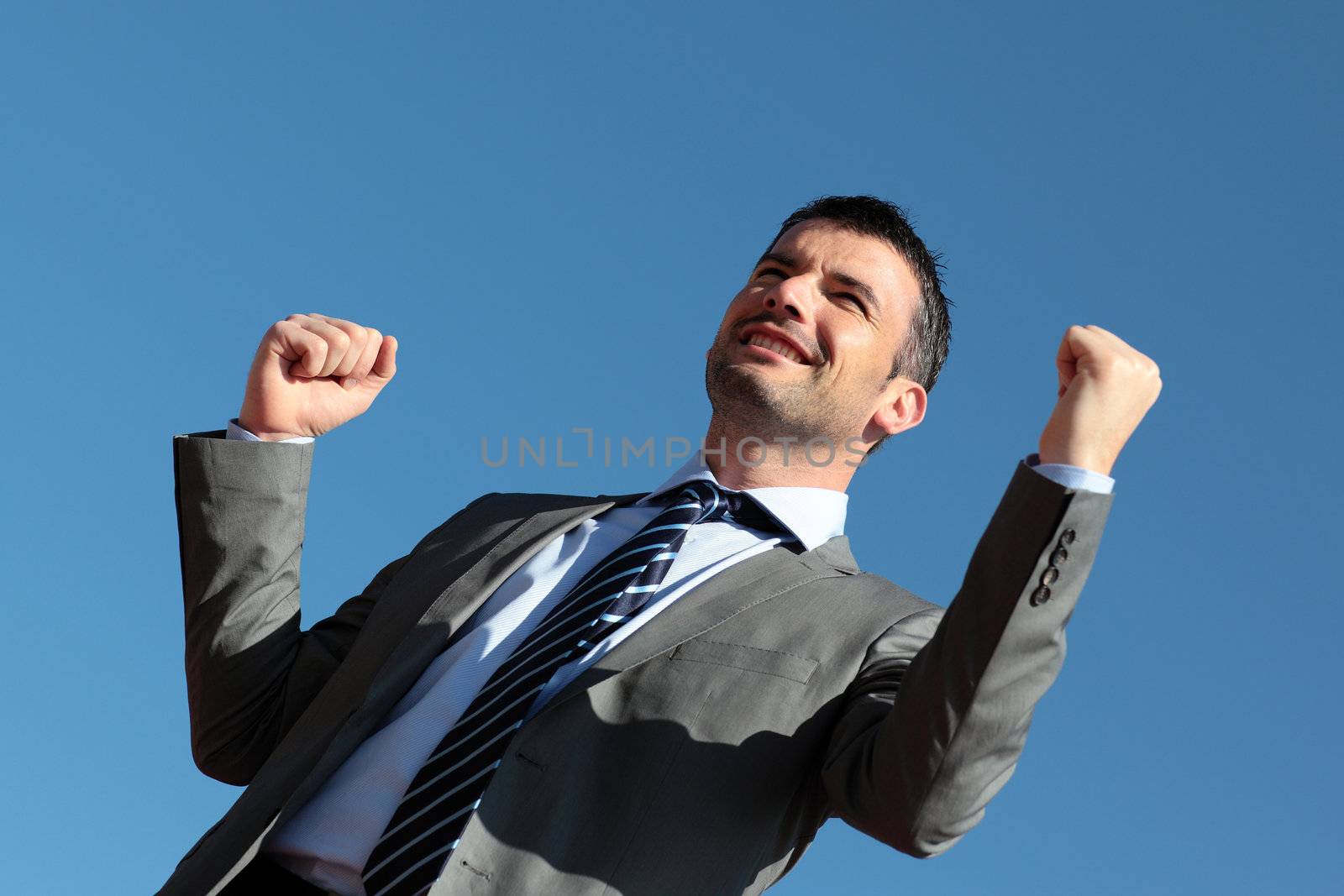 young businessman in blue sky in summer