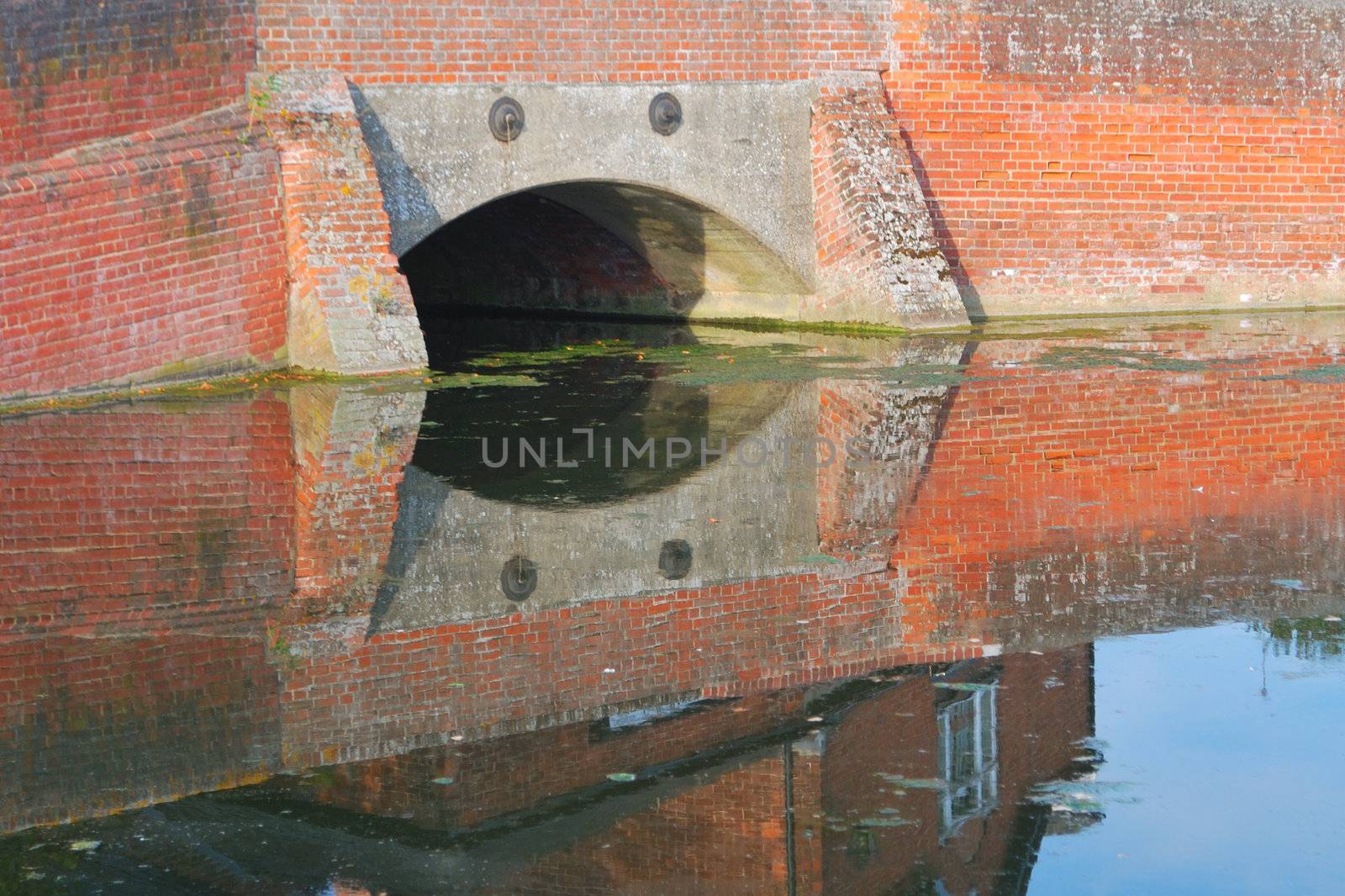 Brick bridge reflected in pond