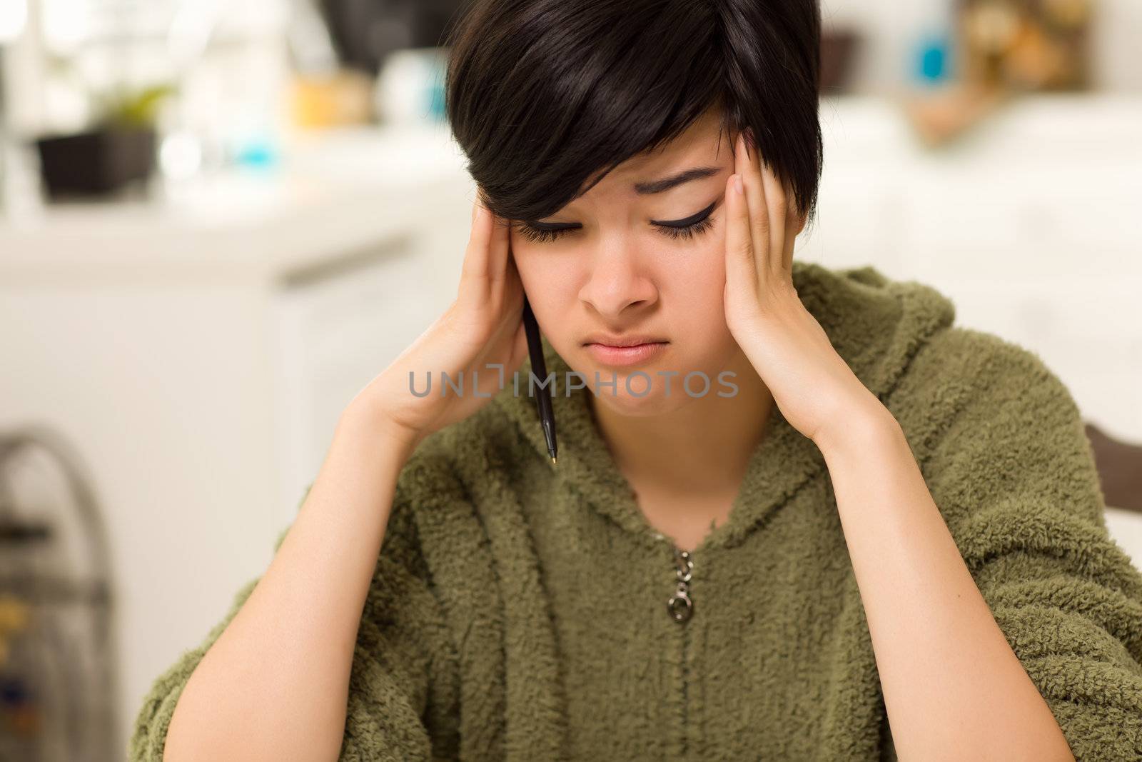 Multi-ethnic Young Woman Rubbing Her Temples Because of Stress.