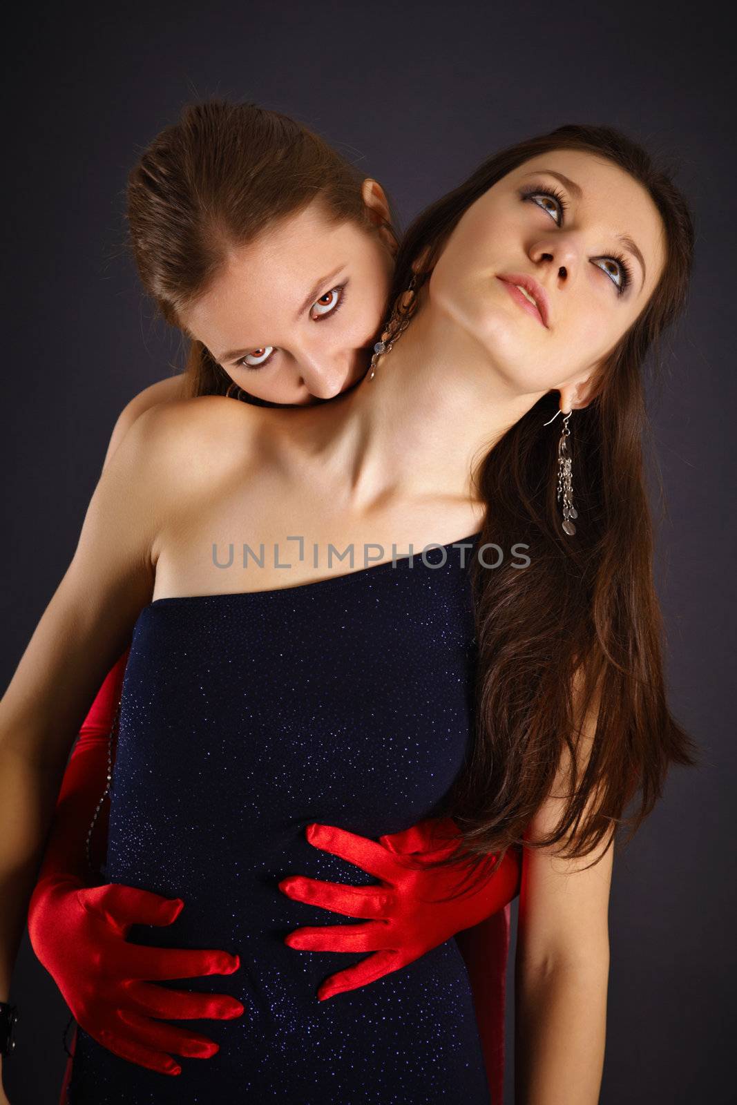 Two young girls portrayed the vampire and his sacrifice on dark background