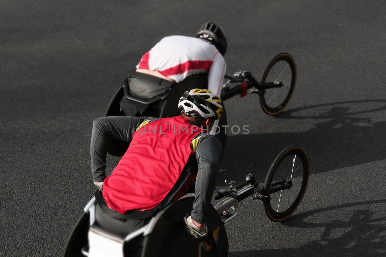 two athletes racing a marathon on wheelchairs