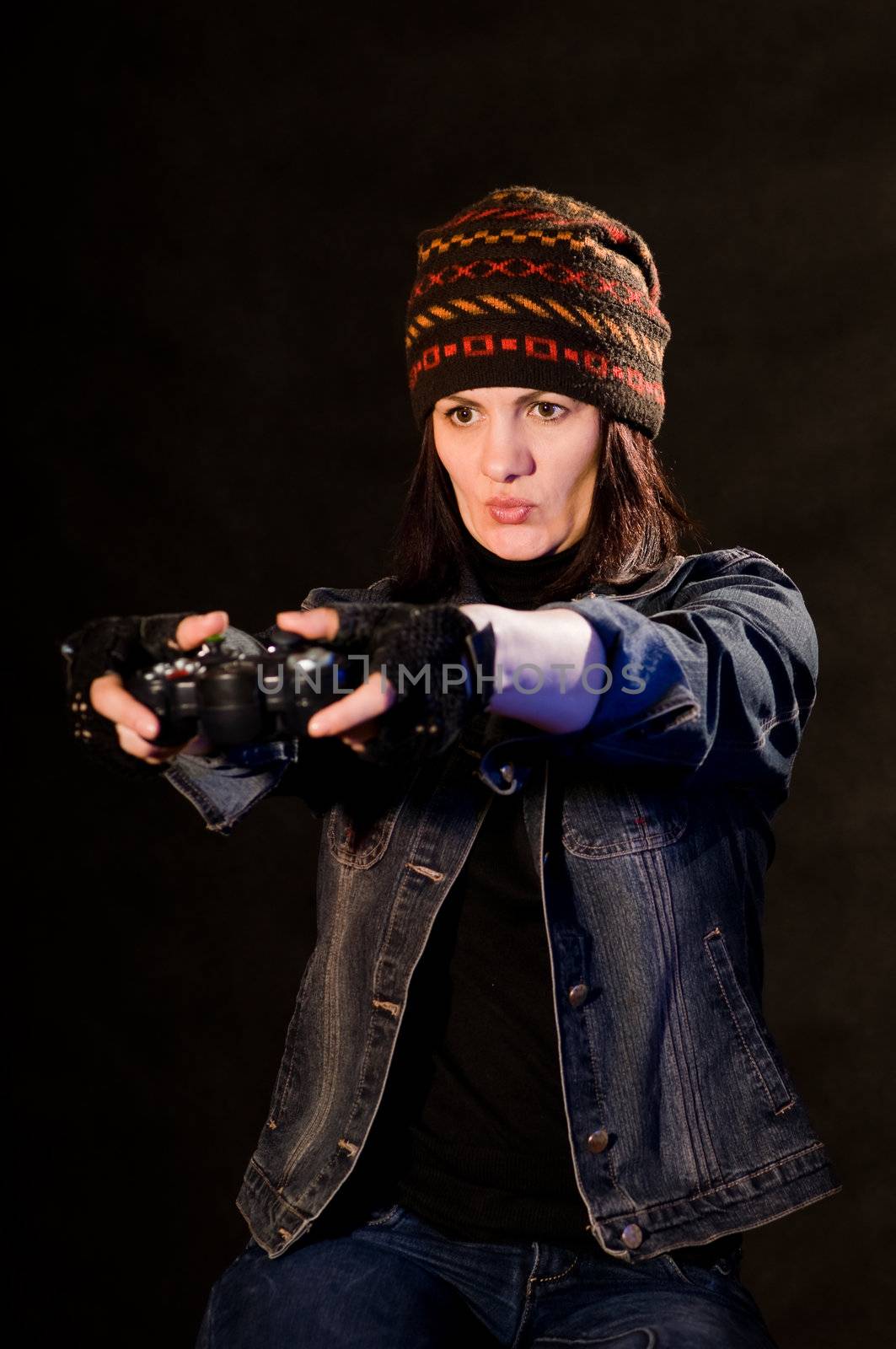 woman gamer with joystick  on darken background