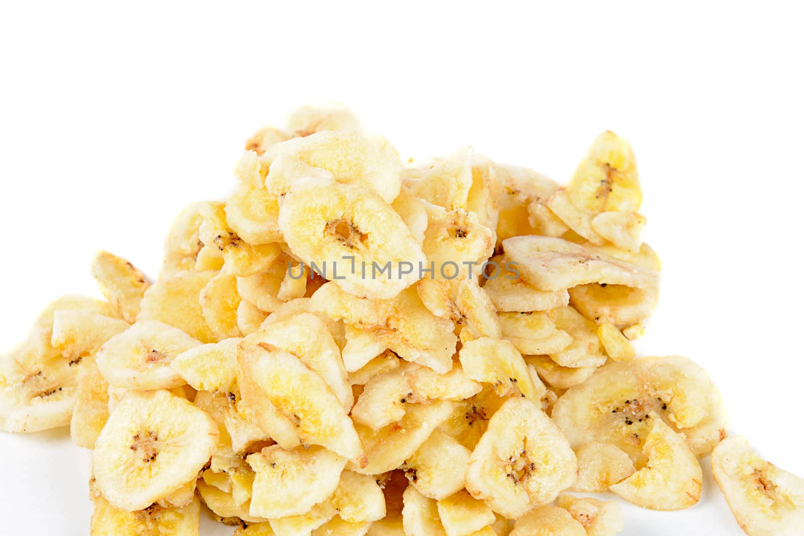 A pile of dried banana chips, isolated against a white background.