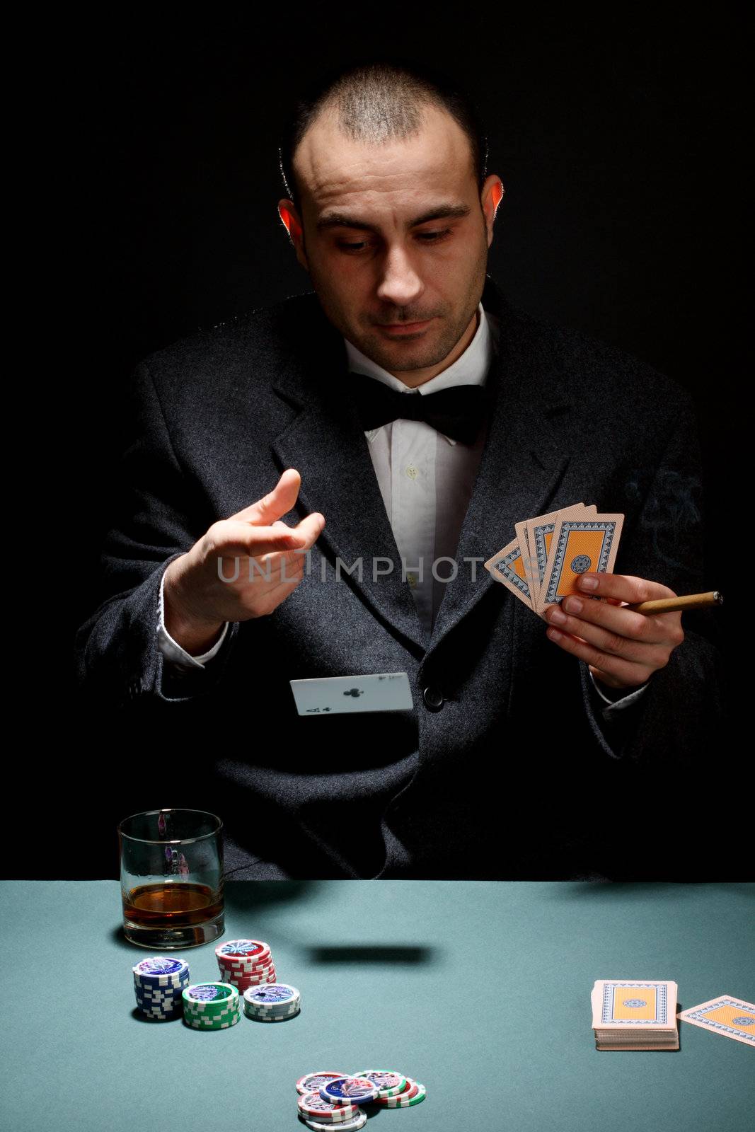 Portrait of a poker player over black background 