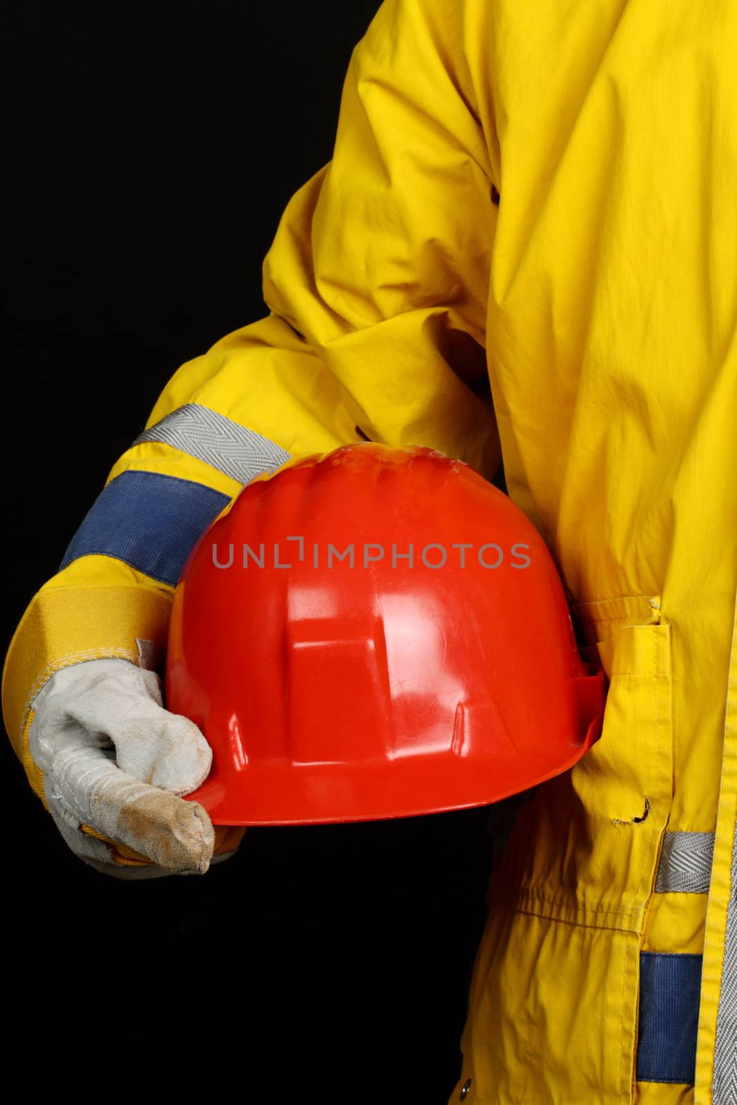 man holding red helmet over black background 