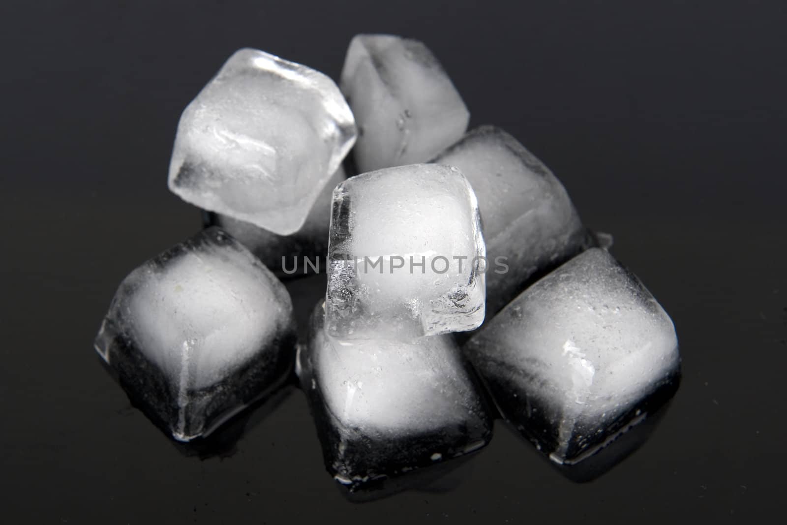 a pile of ice-cubs on a black background