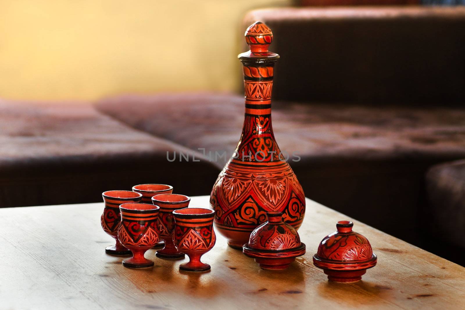 Decorated Moroccan pottery on table in livingroom - horizontal and shallow debt of field