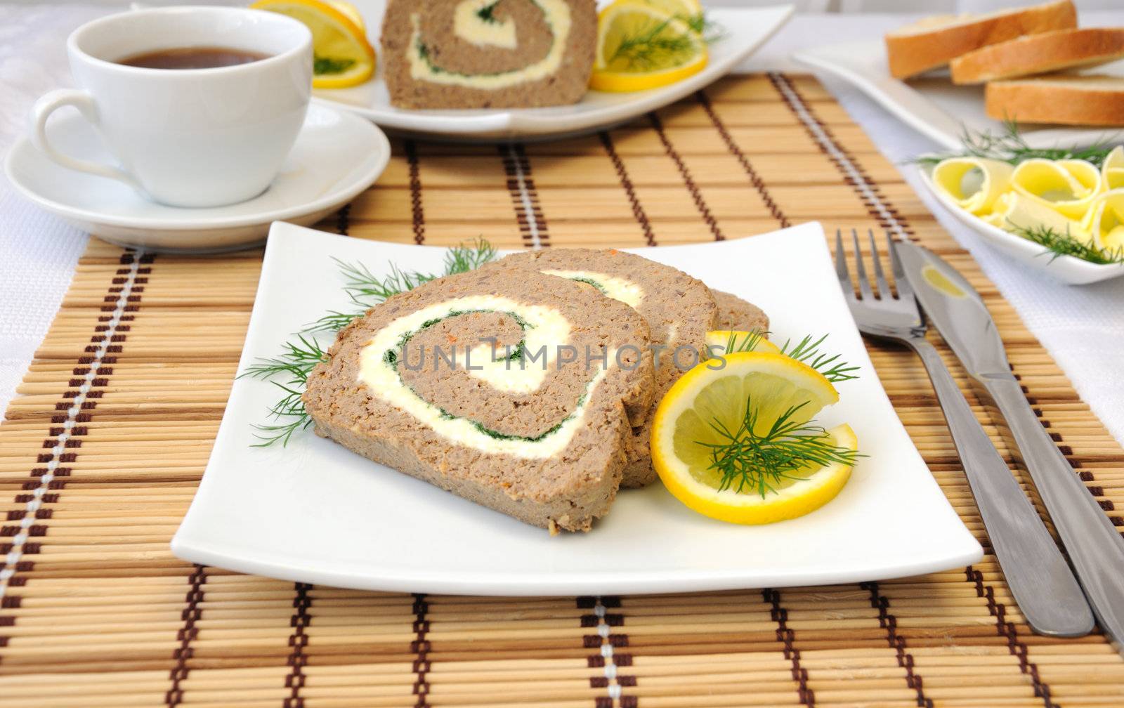 Slices of liver pate with butter and coffee for breakfast