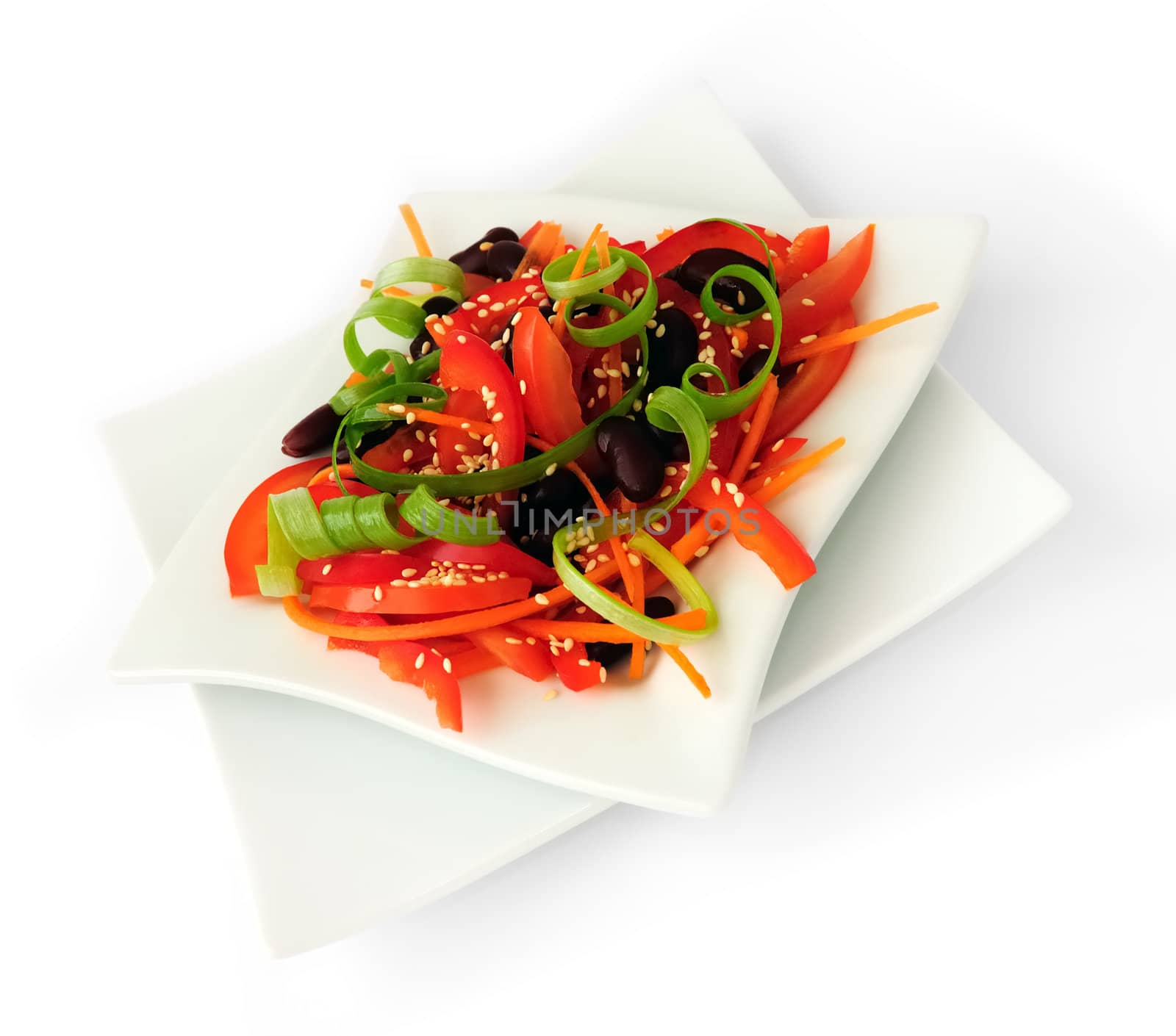 A salad of tomatoes, sweet peppers, red beans, carrots with sesame