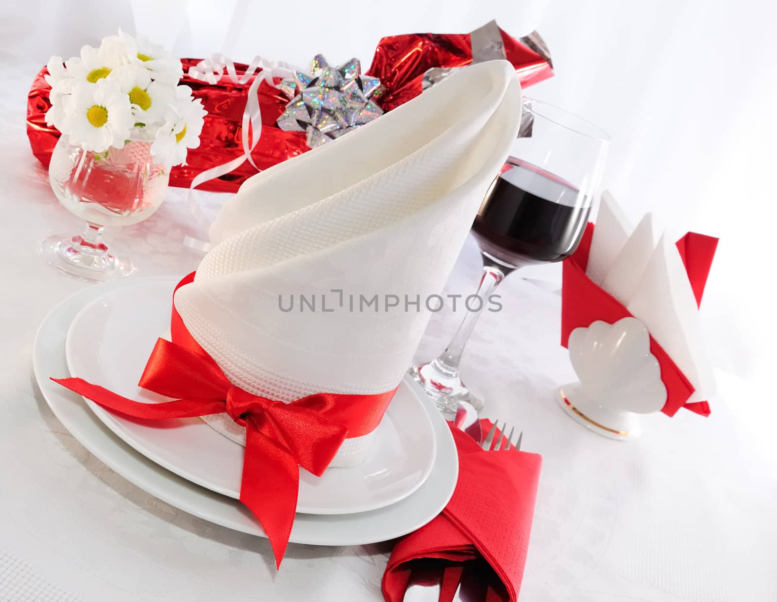 Table setting for a holiday napkin, flowers, wine