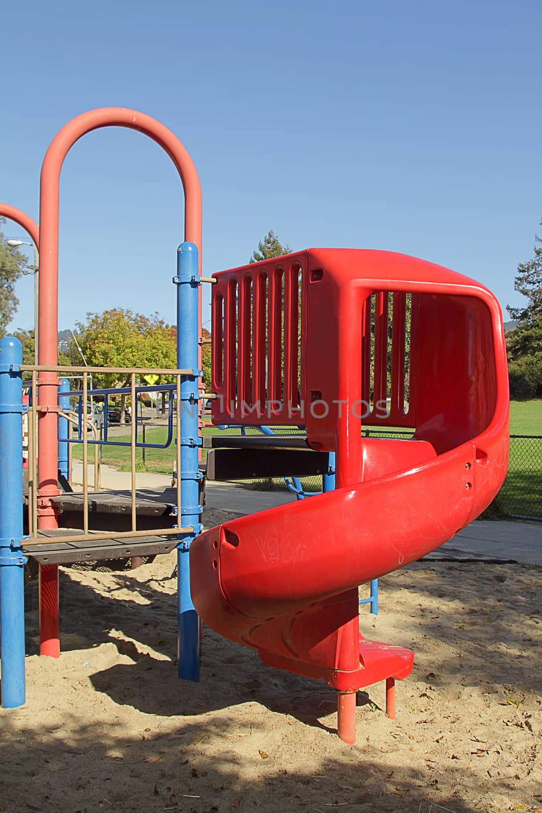 Children's playground with red slide on sunny day