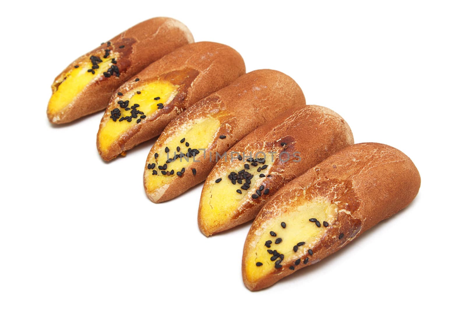 Three Japanese cakes with black sesame seeds isolated over white background