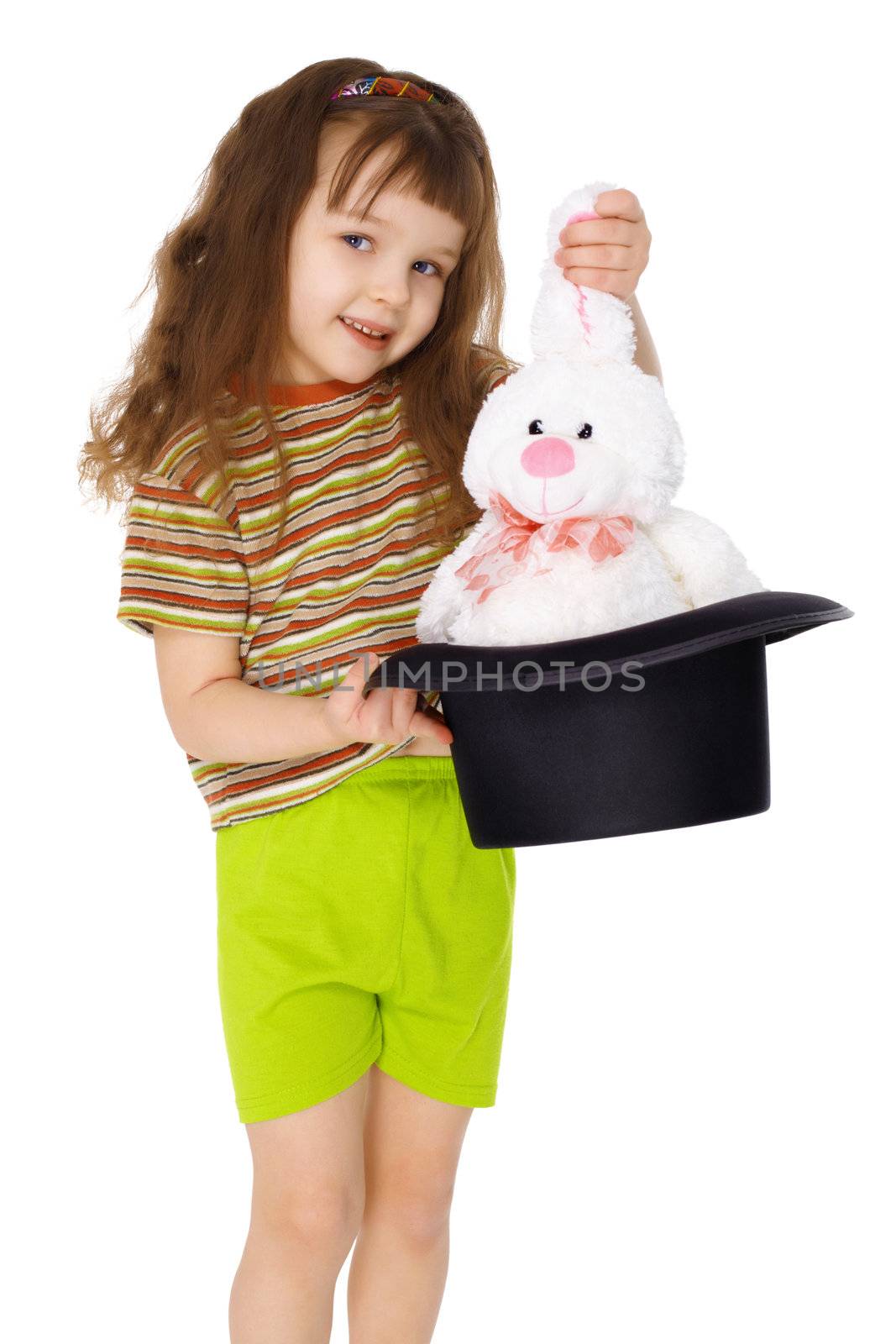 A child gets a rabbit out of a hat like a magician isolated on white background