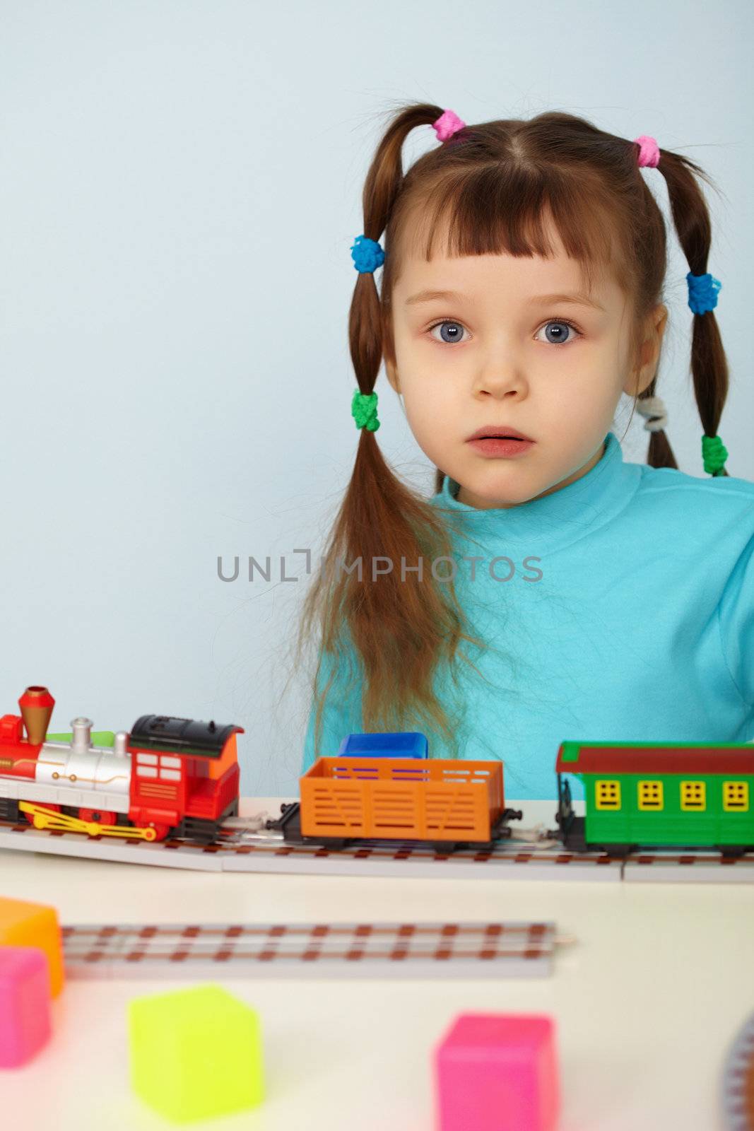 The amazed child and color toy railway