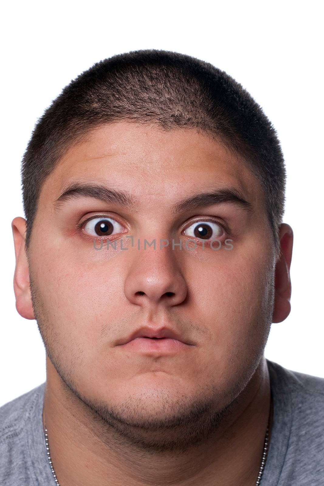 A goofy man wearing trendy nerd glasses isolated over white with a funny expression on his face.