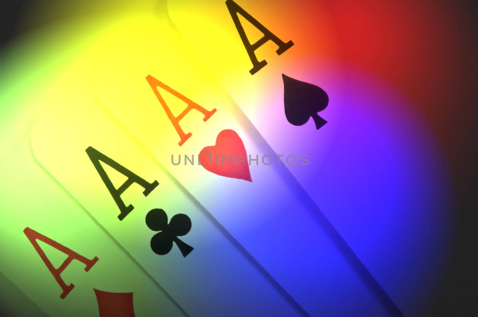 Close up of four ace playing cards with multicoloured light effect filter