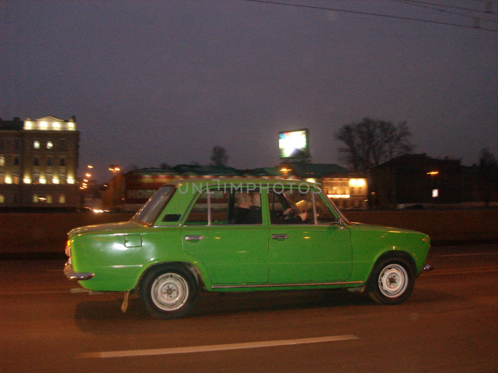 green car running on the road