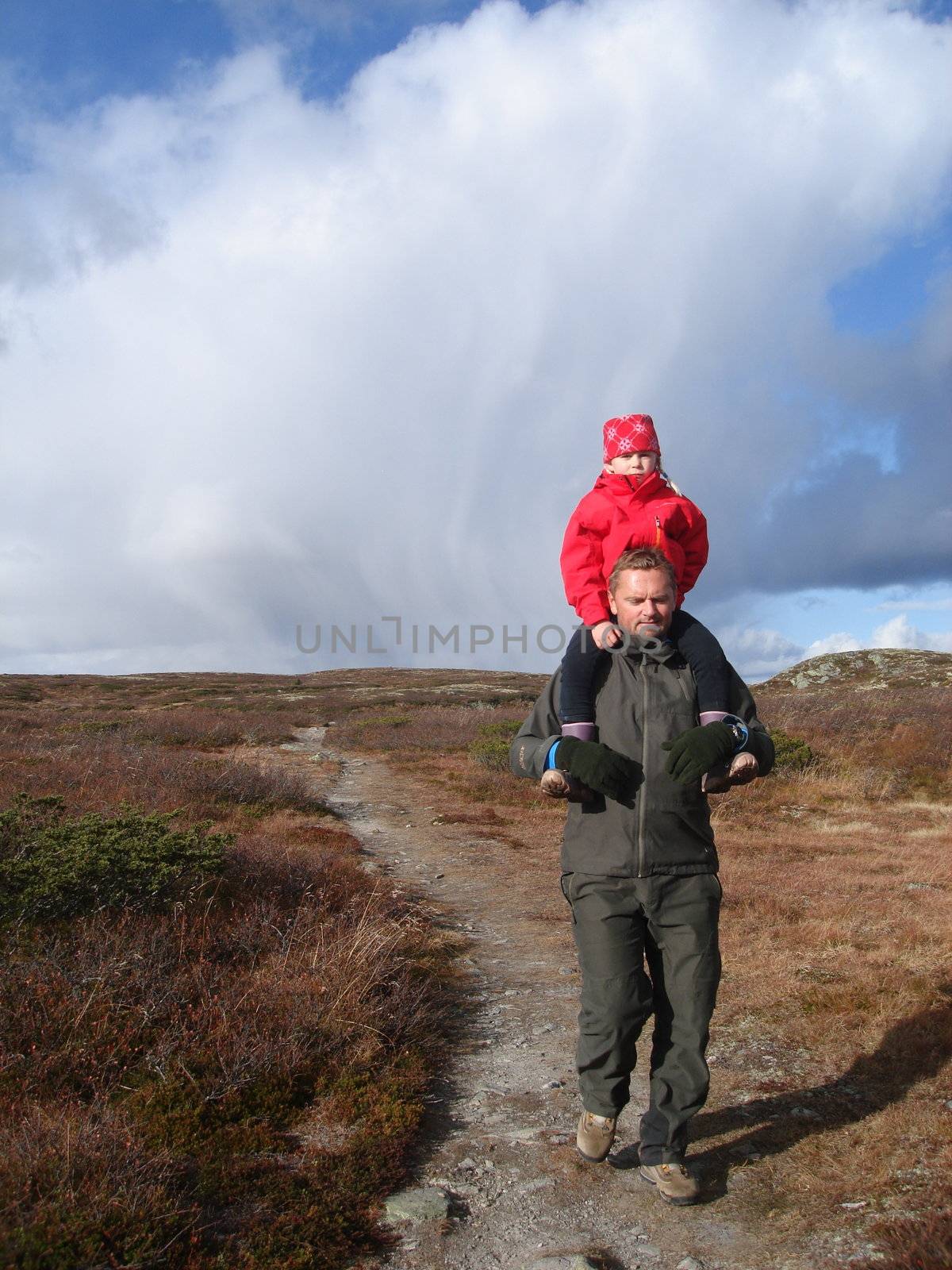 father takes daughter on his shoulder