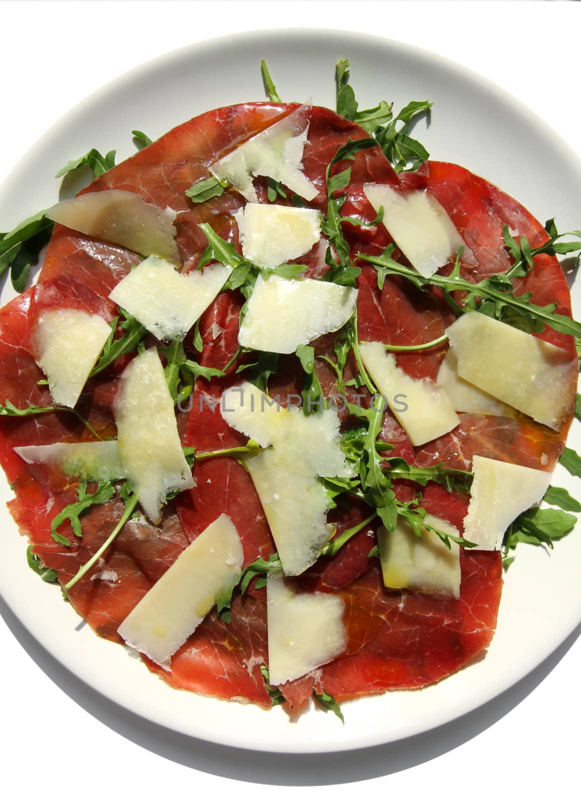 delicious italian Carpaccio plate with beef slices and Parmesan cheese