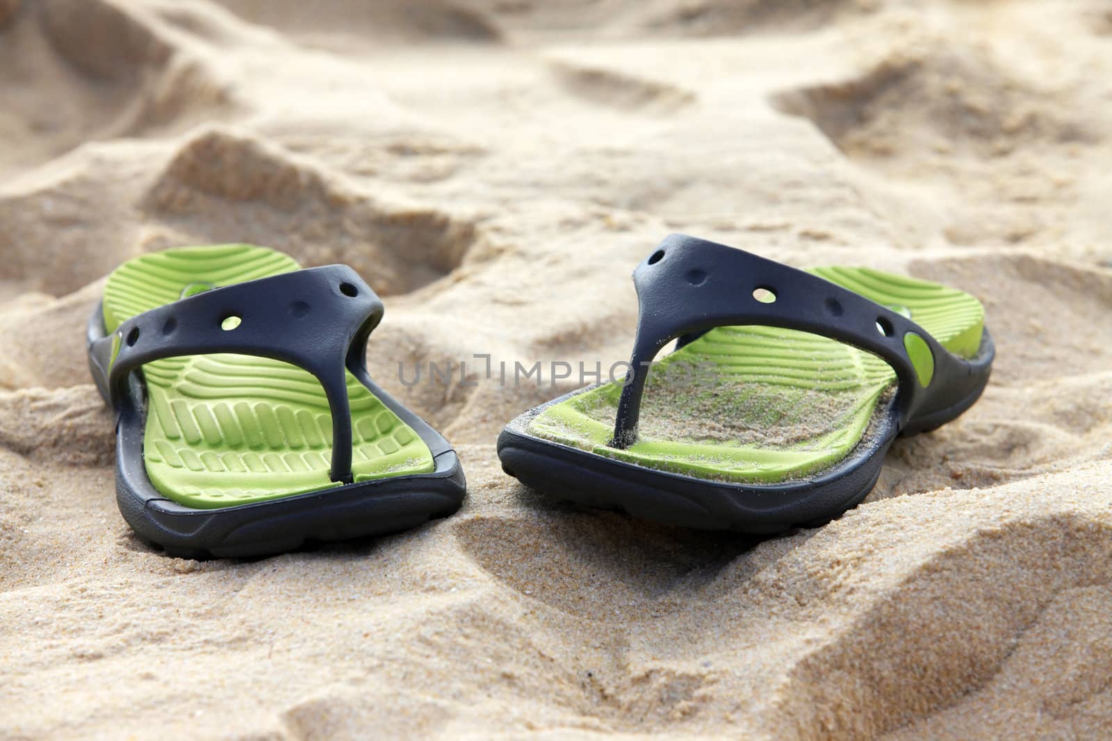 Female slippers on a coast of ocean