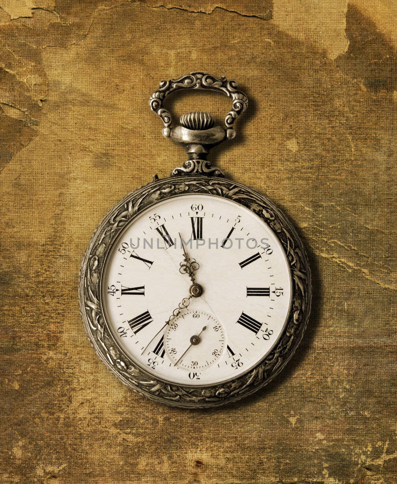 Old Pocket watch from the 1900s on a textured background