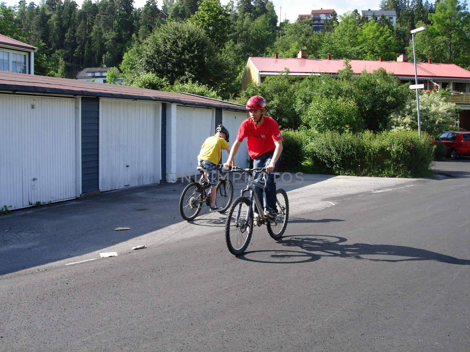 Scandinavian Lifestyle-boy playing with the bike by Bildehagen