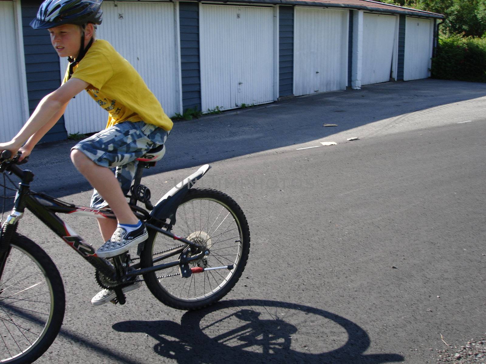 Scandinavian Lifestyle-boy playing with the bike by Bildehagen