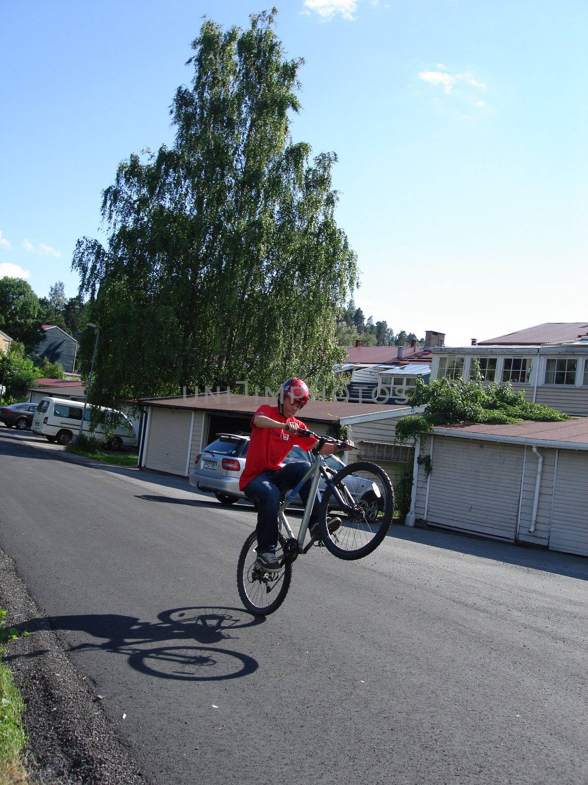 Scandinavian Lifestyle-boy playing with the bike by Bildehagen