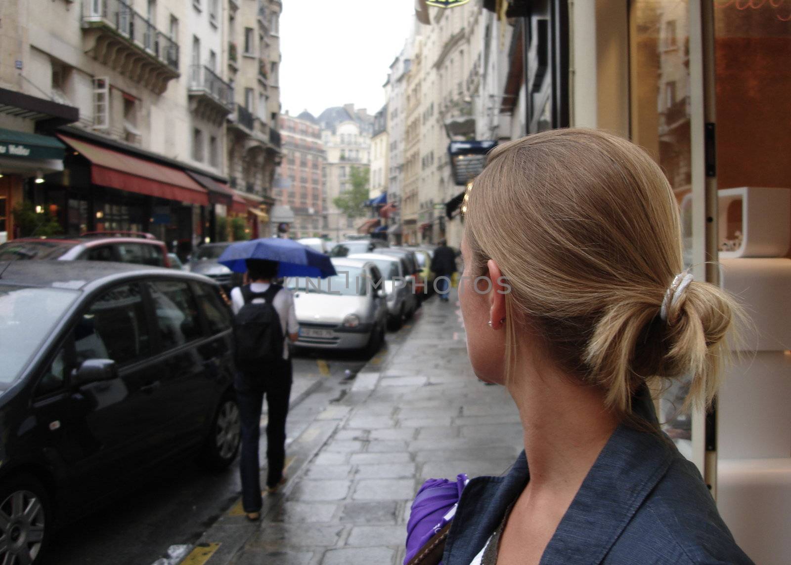 Scandinavian Lifestyle-woman looking over the street by Bildehagen