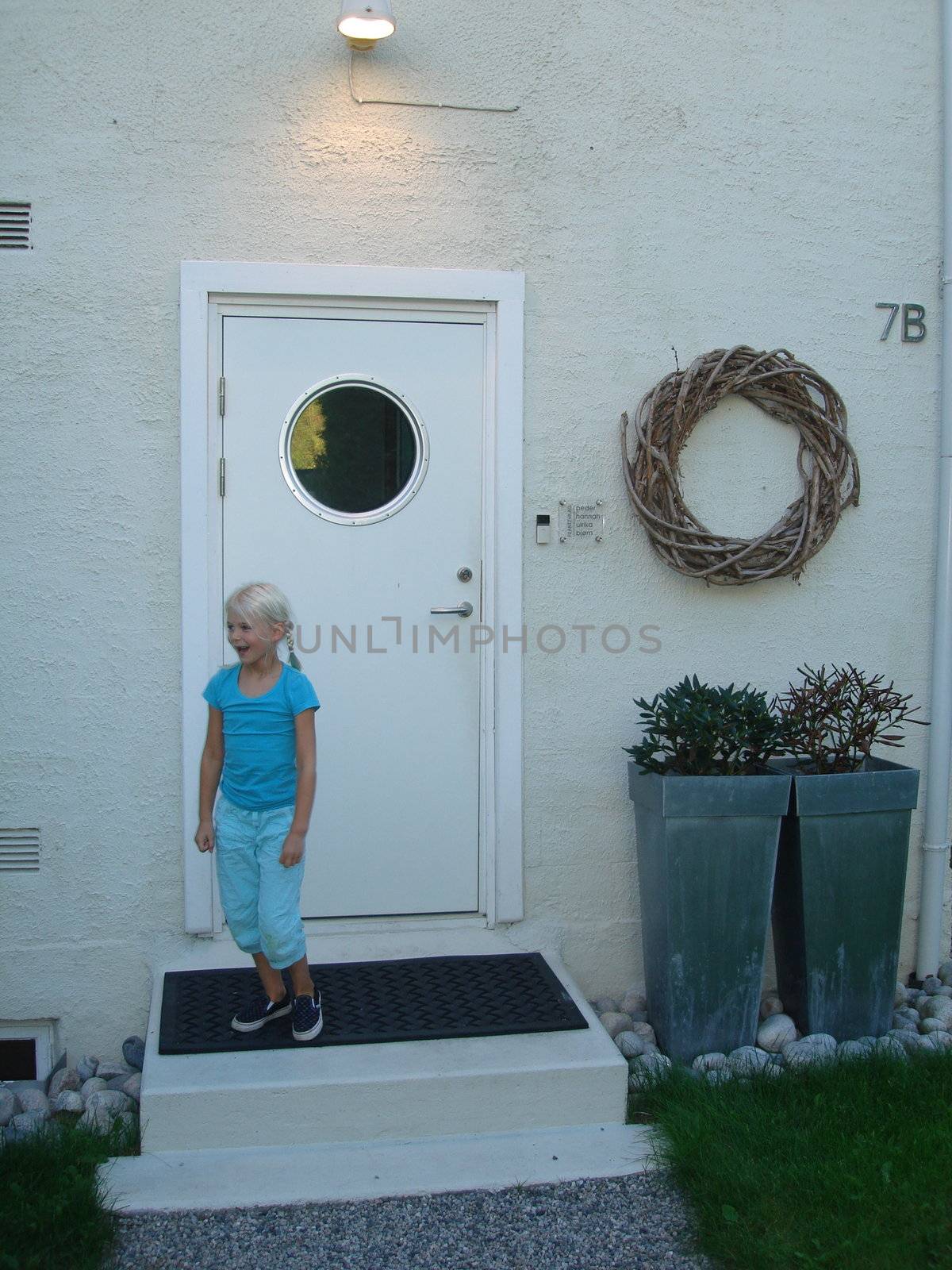Scandinavian Lifestyle-girl at front of the house by Bildehagen