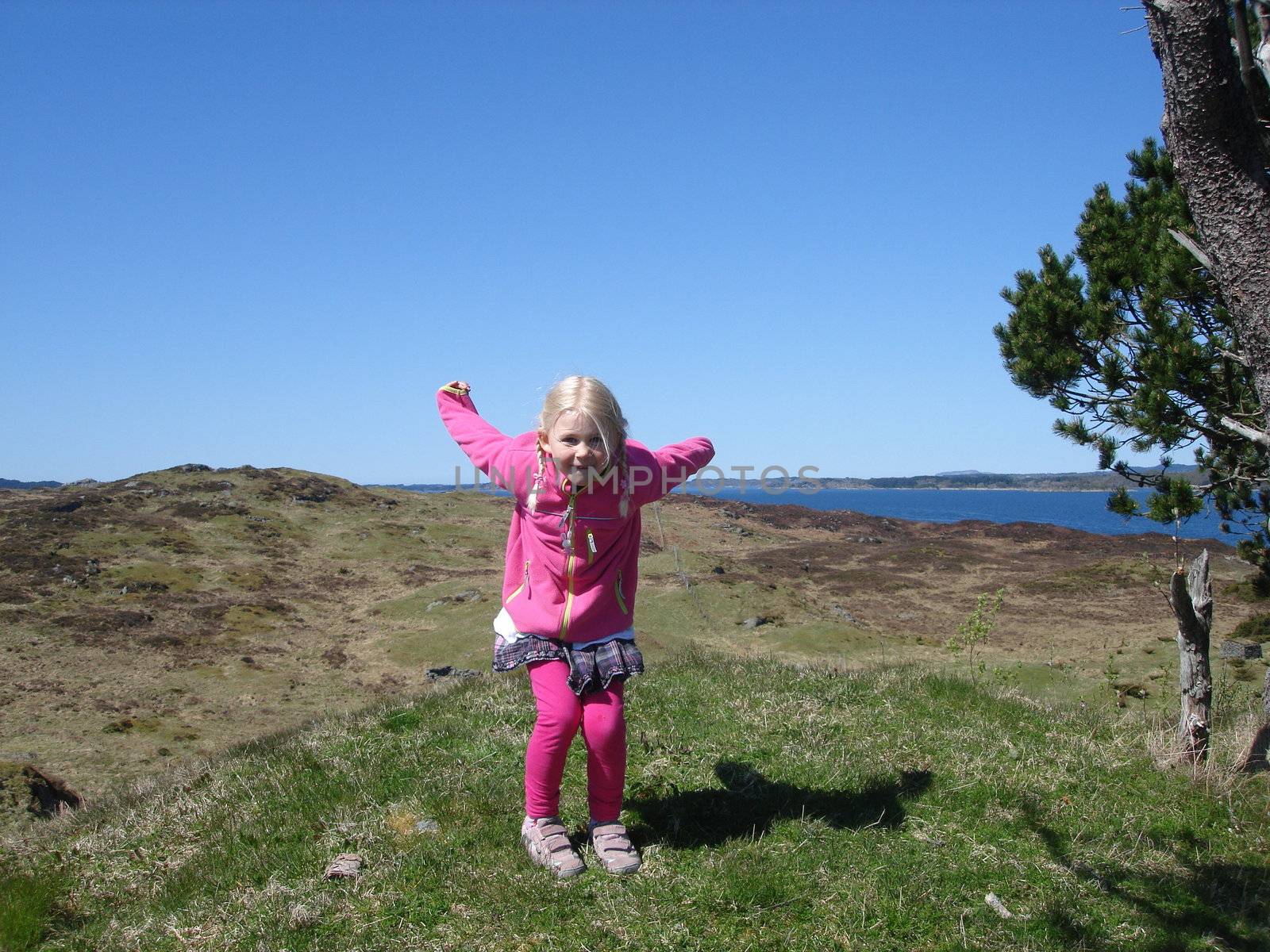 Scandinavian Lifestyle-girl jumping in wild by Bildehagen