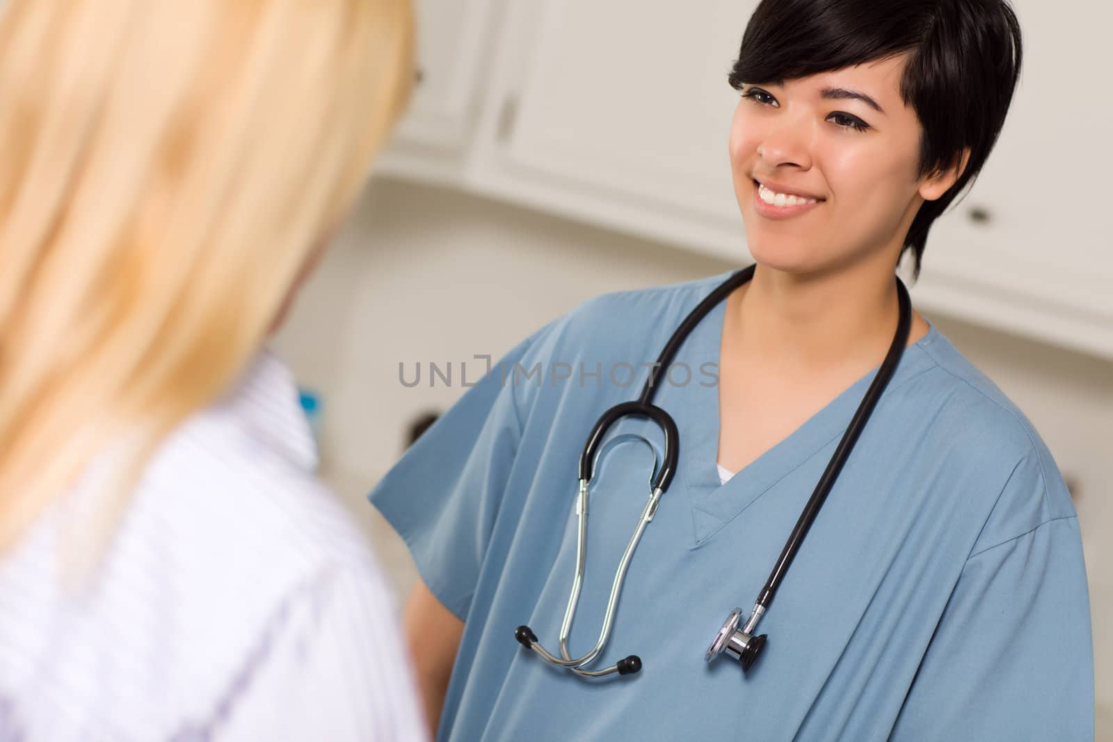 Attractive Mixed Race Young Female Doctor Talking with Patient by Feverpitched