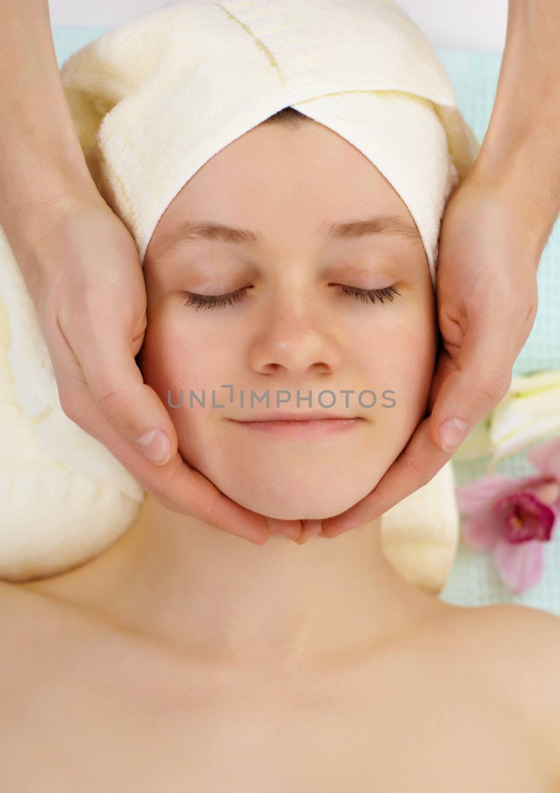 Young woman doing facial in beauty salon by pzaxe